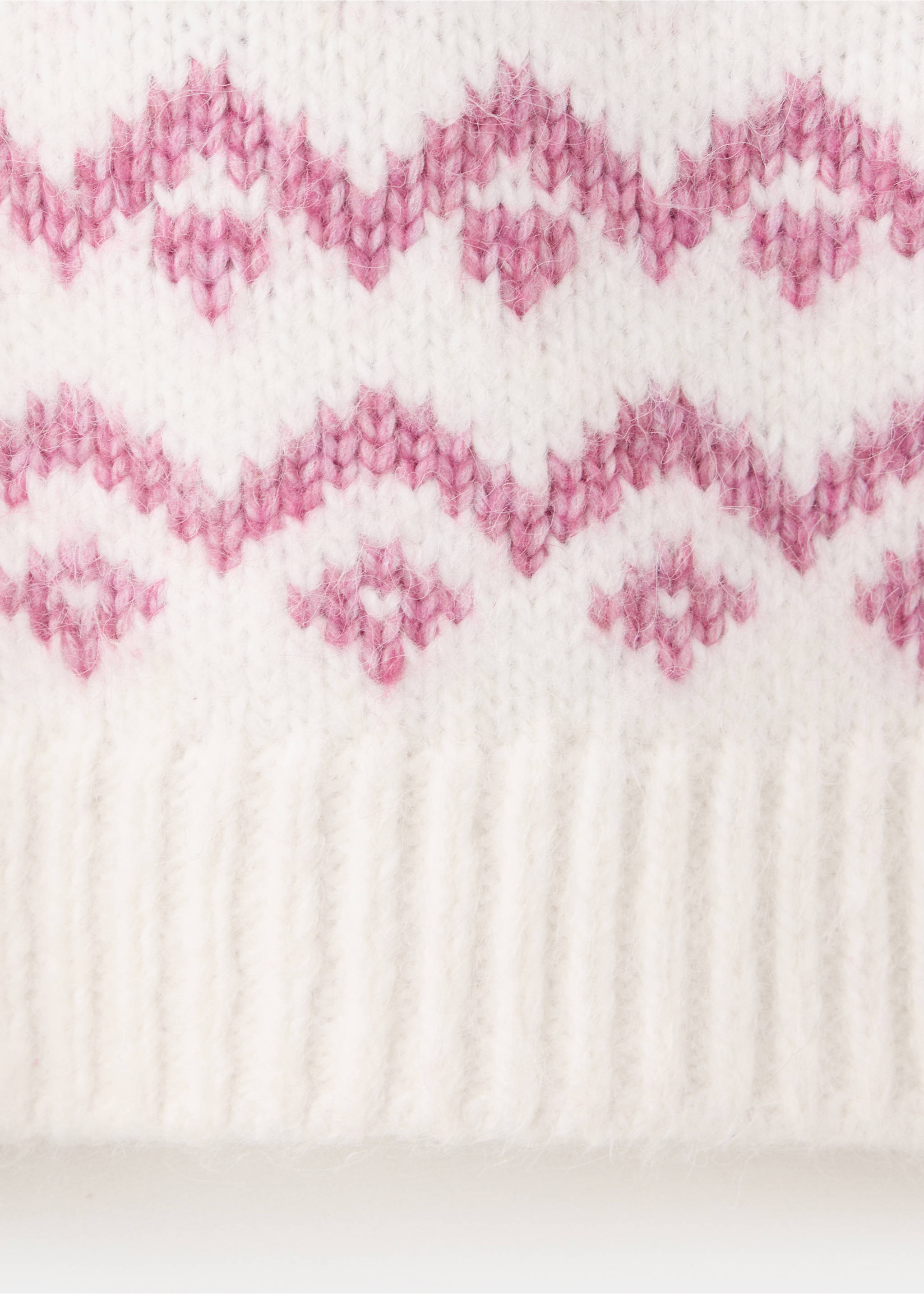 Close-up of a fuzzy white knitted jersey with a pink fair isle pattern and ribbed hem., Pink. Ref: 37007127-00.