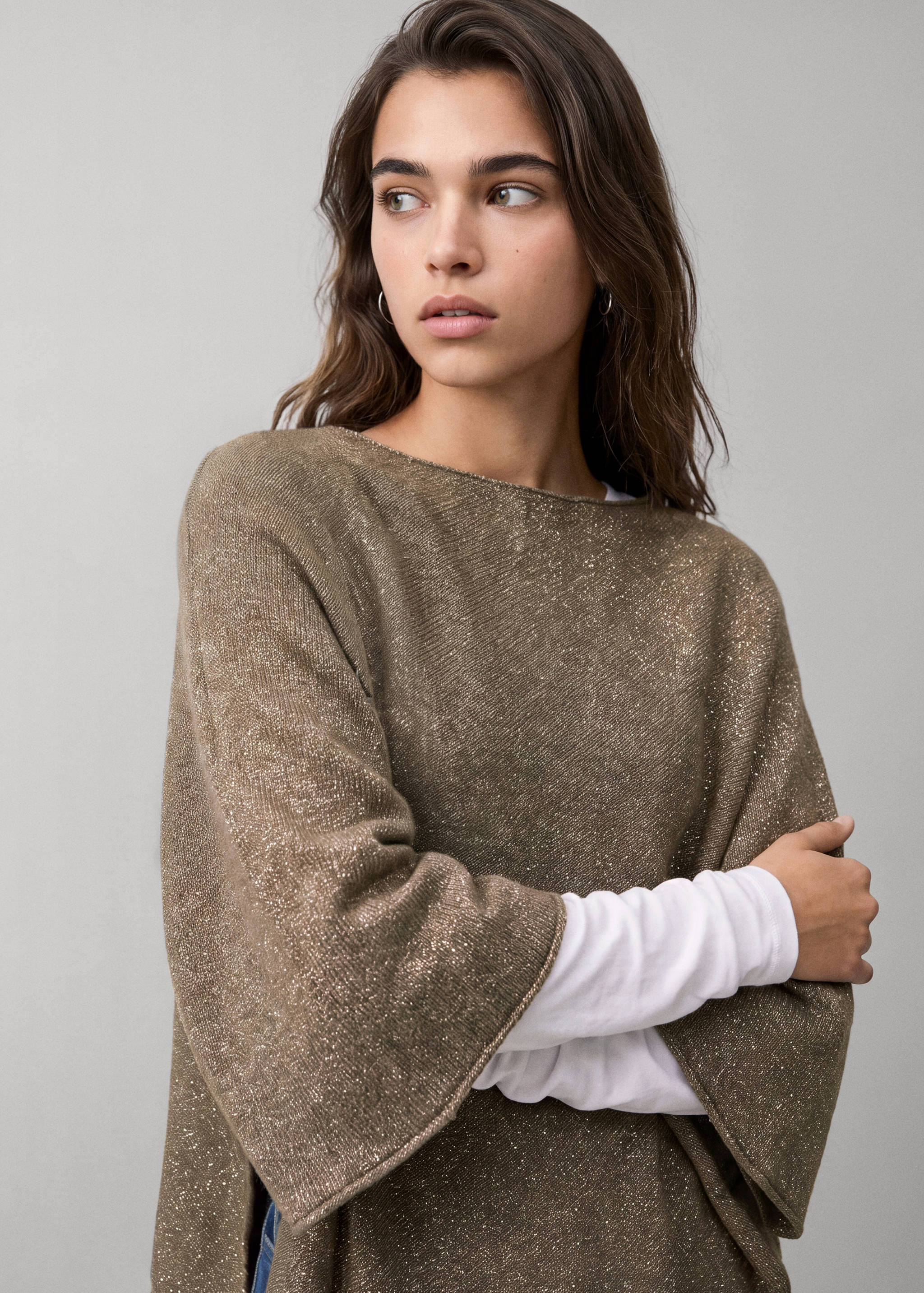 Metallic brown knit jersey with boat neck and wide sleeves, layered over a white top.