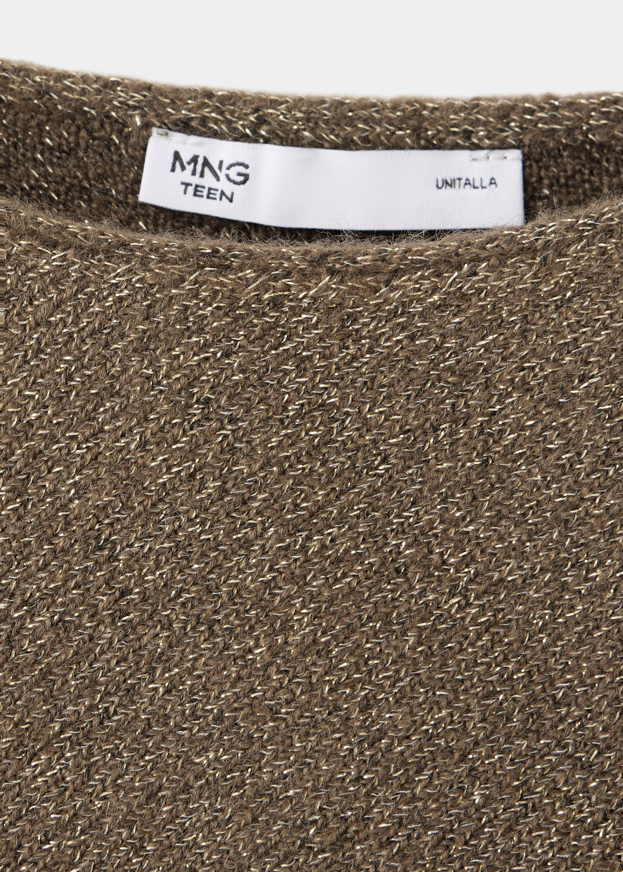 Close-up of a metallic knit jersey in brownish-gold with a branded label.
