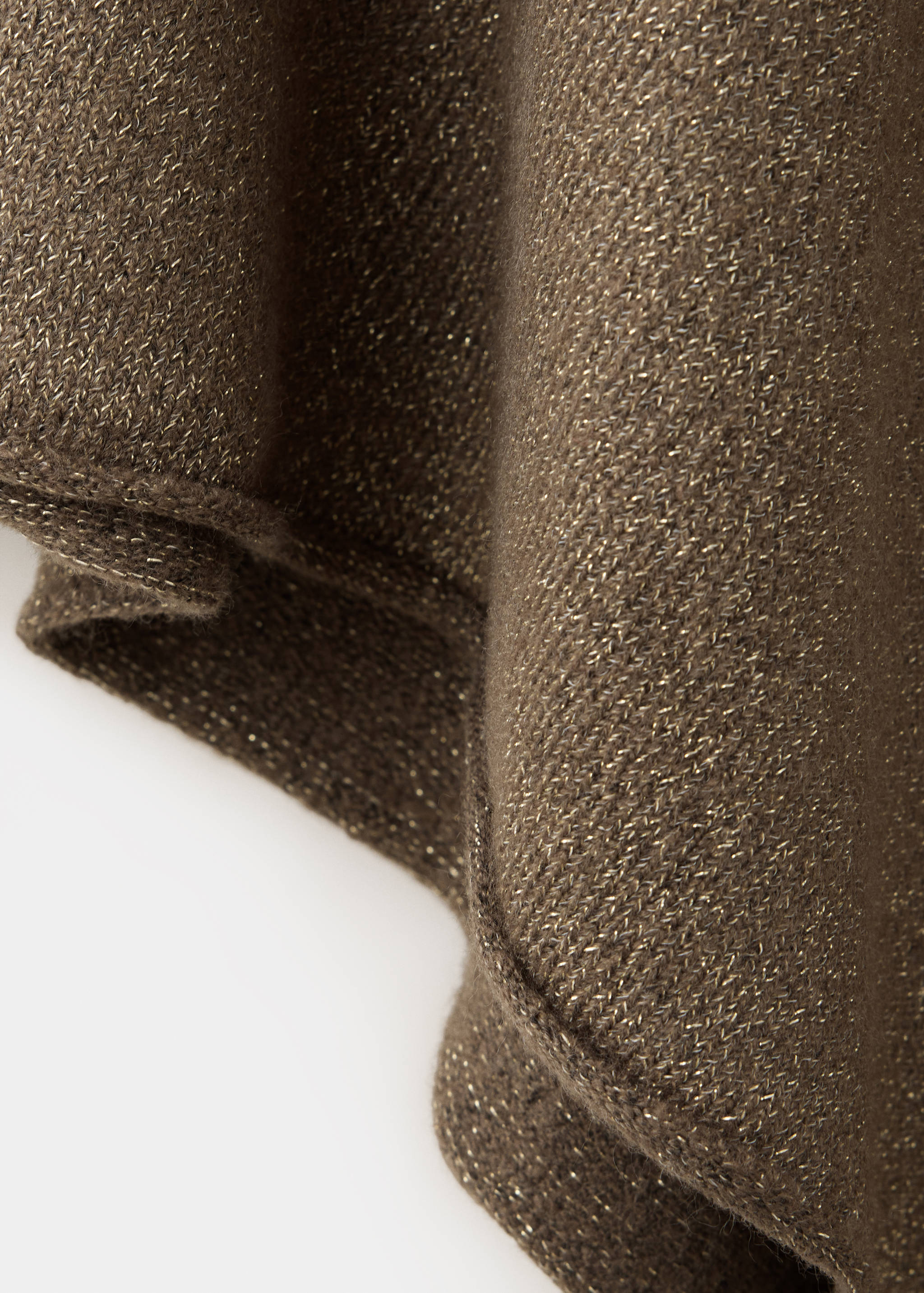 Close-up of a metallic knit sweater fabric in bronze with a fine shimmer.
