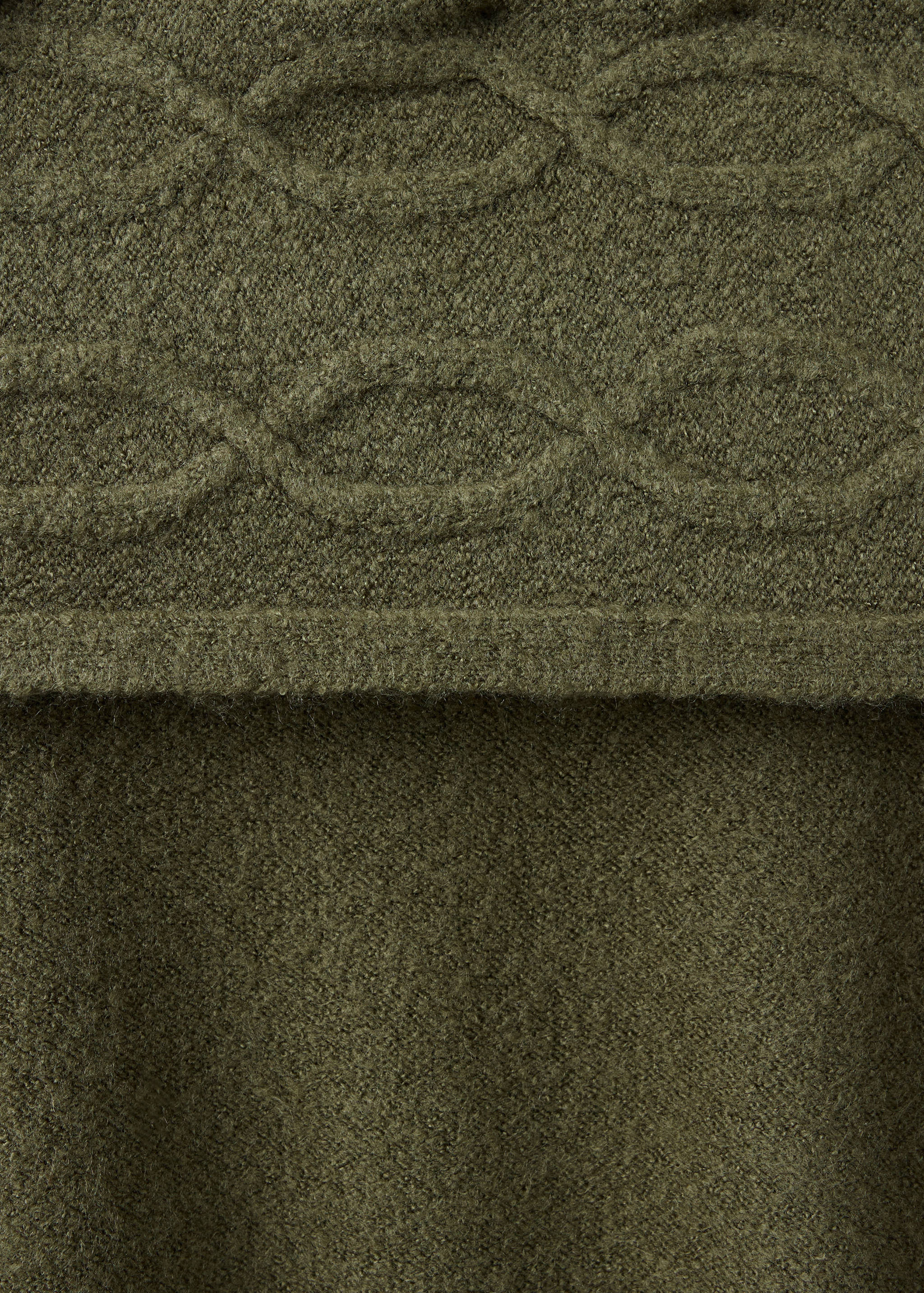 Olive green jersey fabric detail with cable knit band.