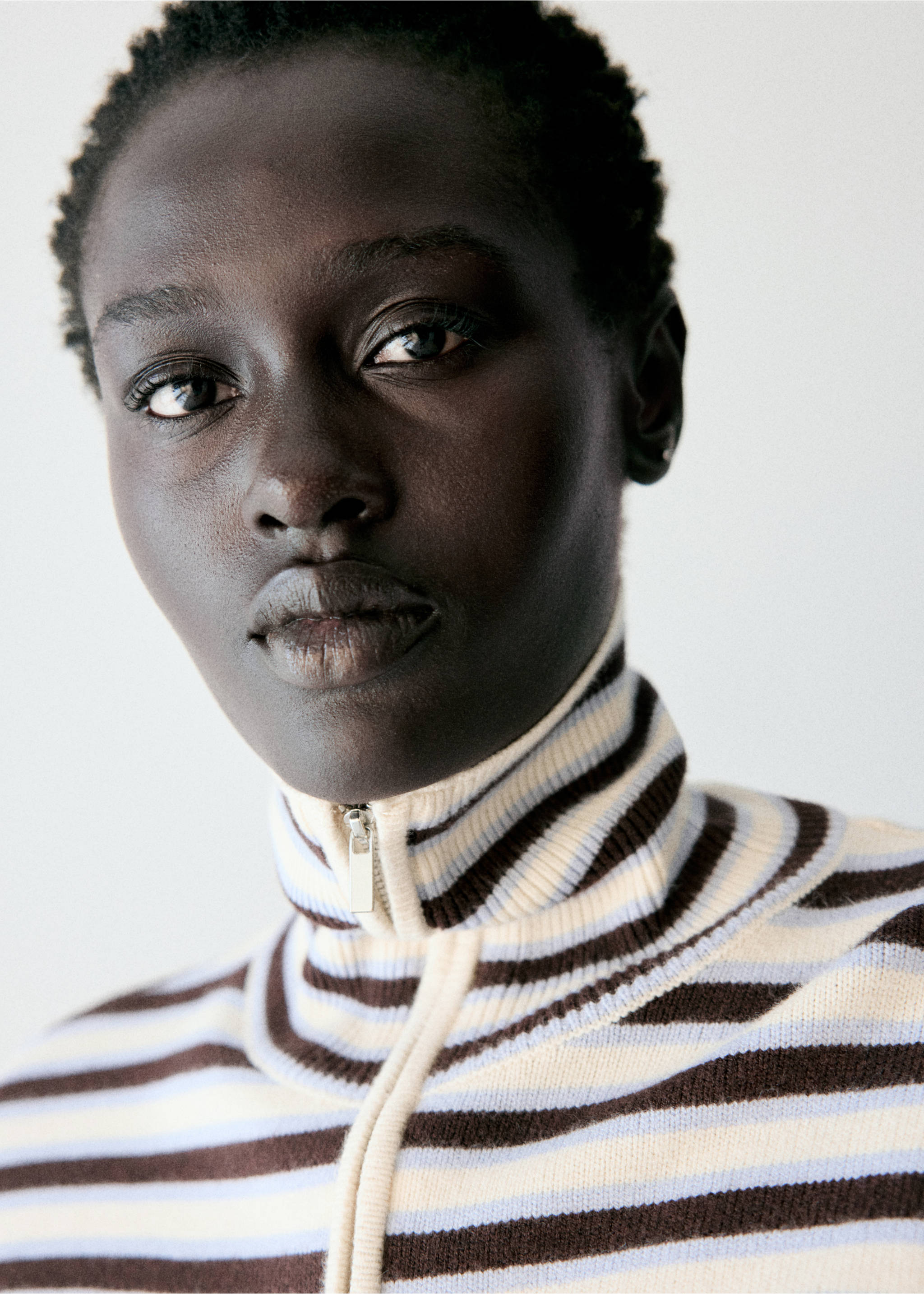 Close-up of a striped knitted jumper with a high zip-up collar., Chocolate. Ref: 37007784-00.