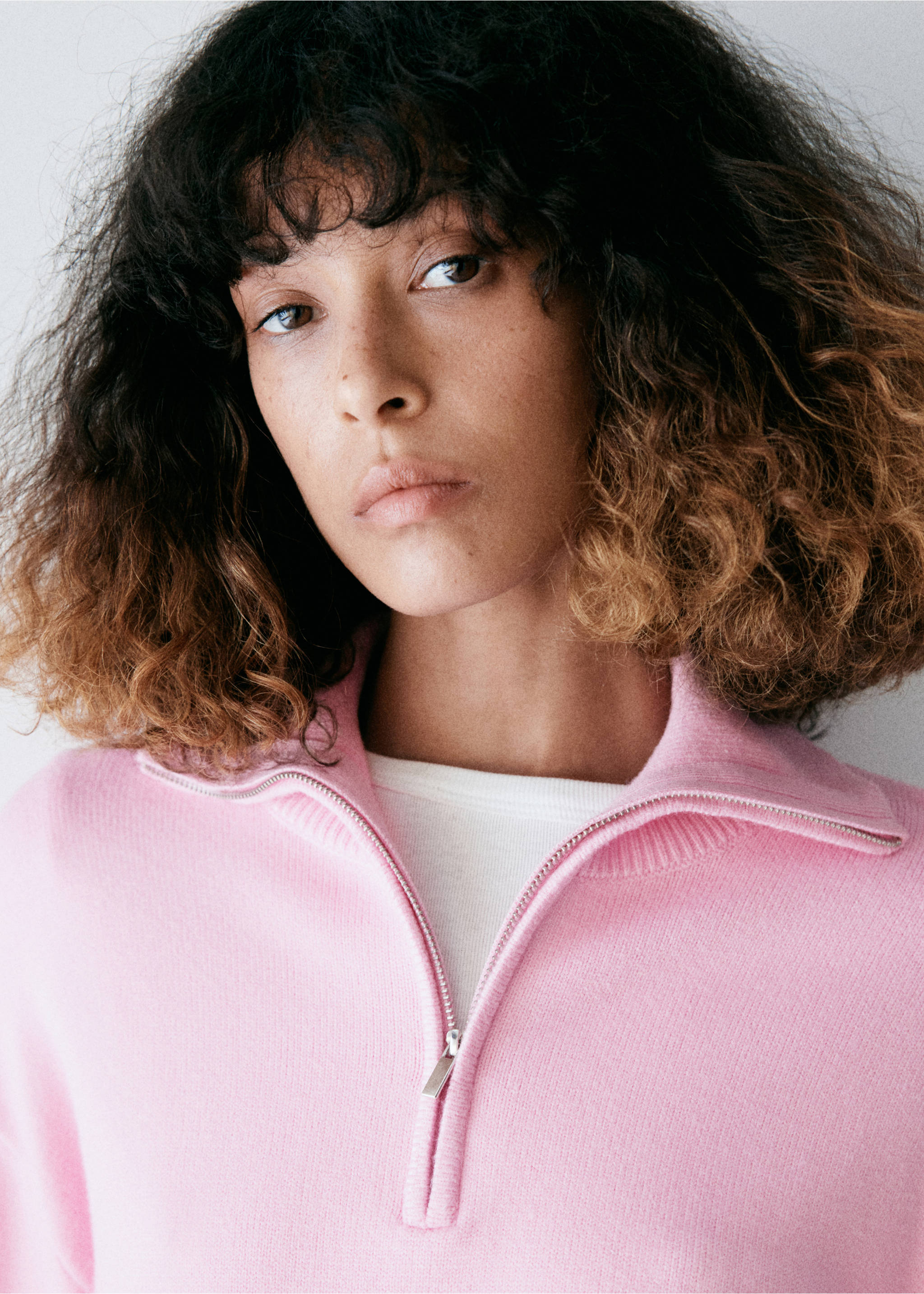 Pink knitted jersey with a quarter-zip collar, worn with a white inner layer., Light Pink. Ref: 37007784-00.