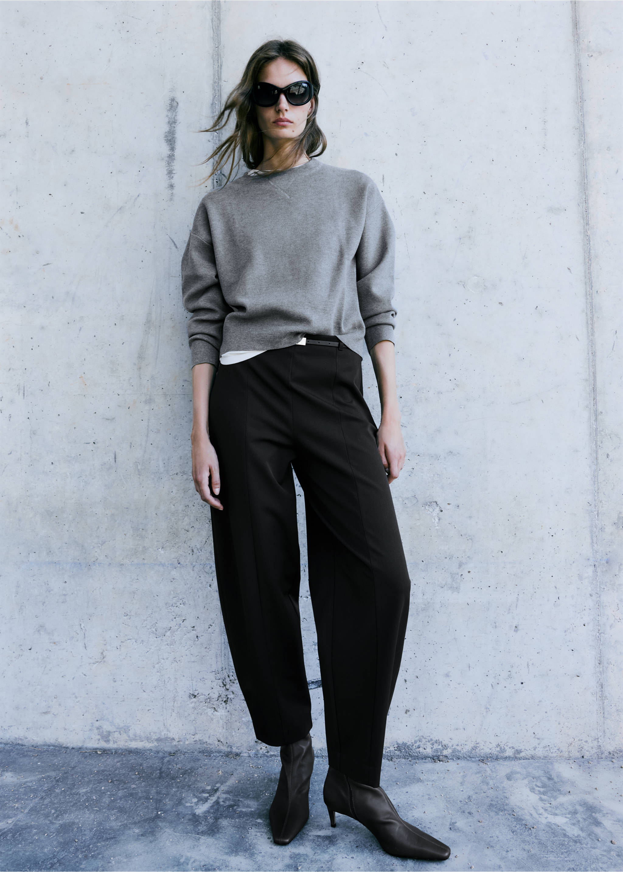Grey crew-neck jersey sweater with dropped shoulders, worn with dark trousers., Grey. Ref: 37007785-00.