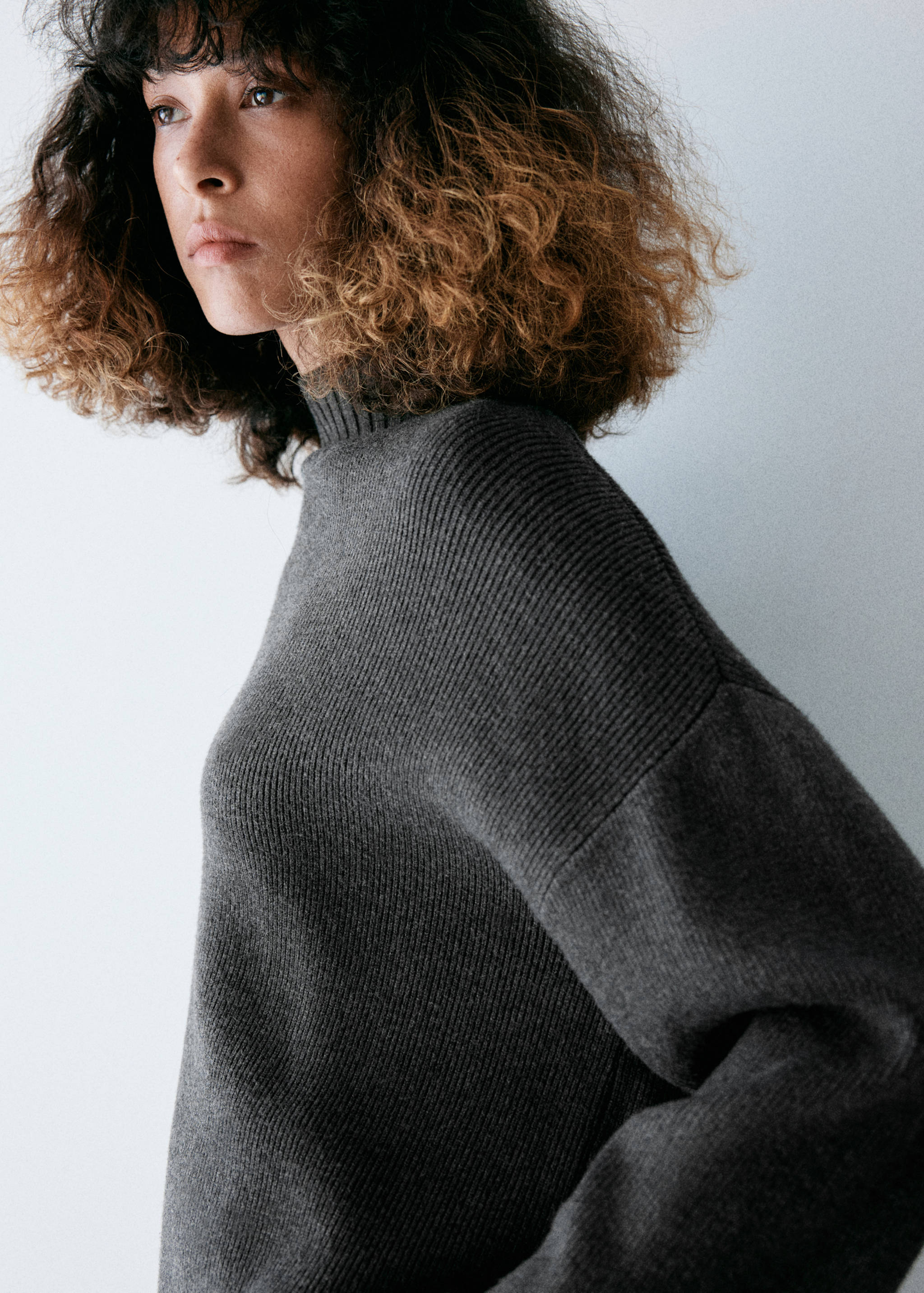 Dark grey ribbed turtleneck jersey, close-up view.