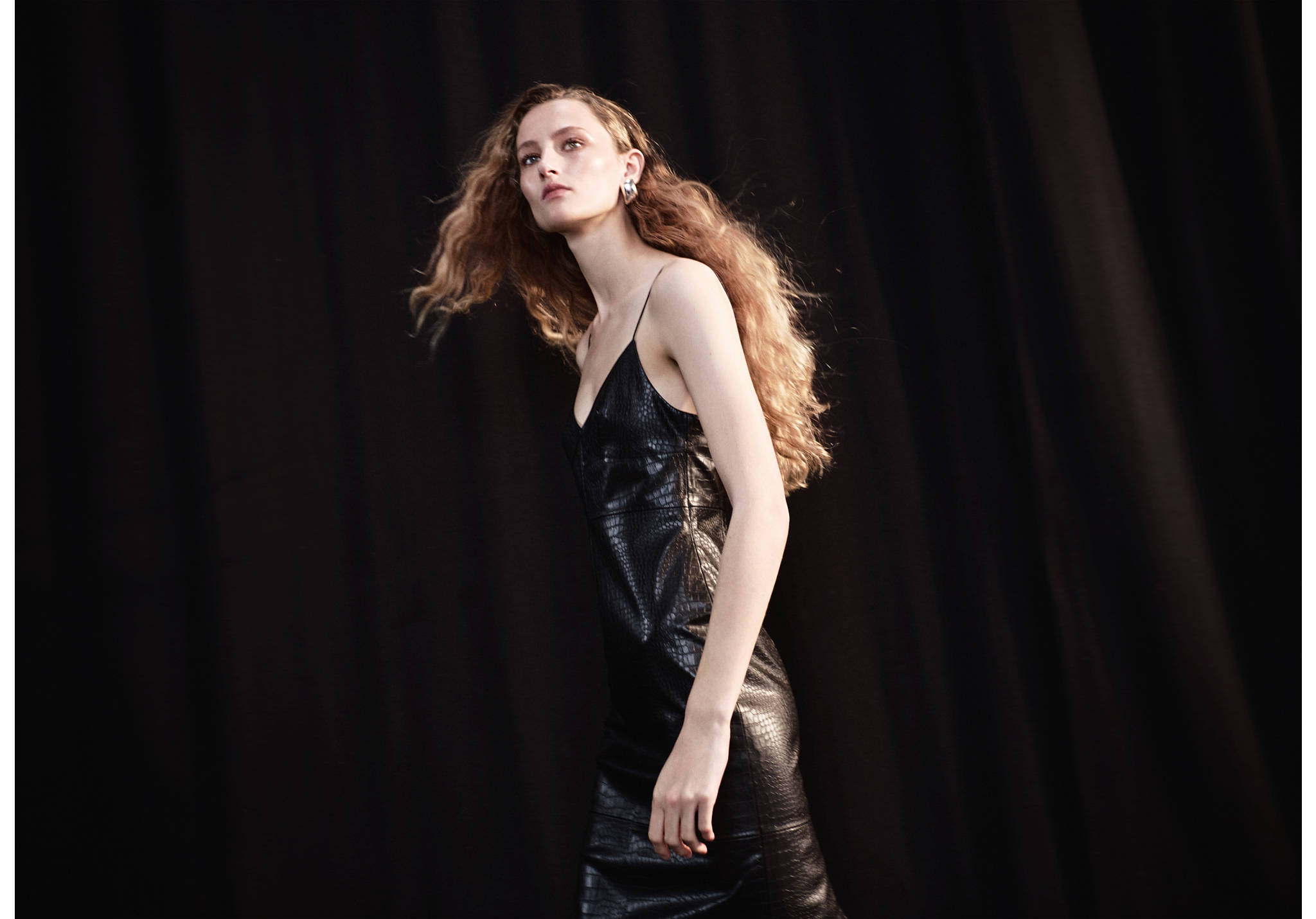 Black crocodile-embossed slip dress with thin spaghetti straps.