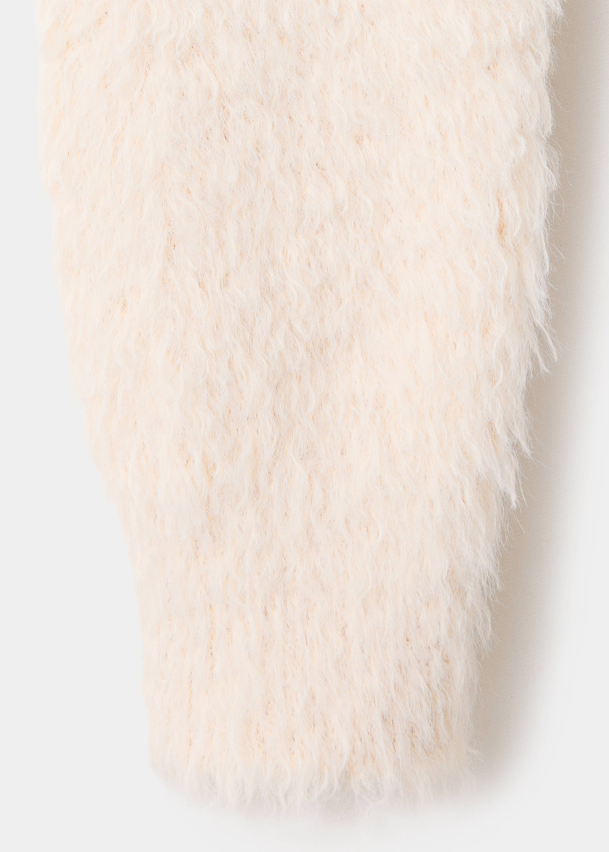 Close-up of a pale pink jersey showing its fuzzy, shaggy knit texture.