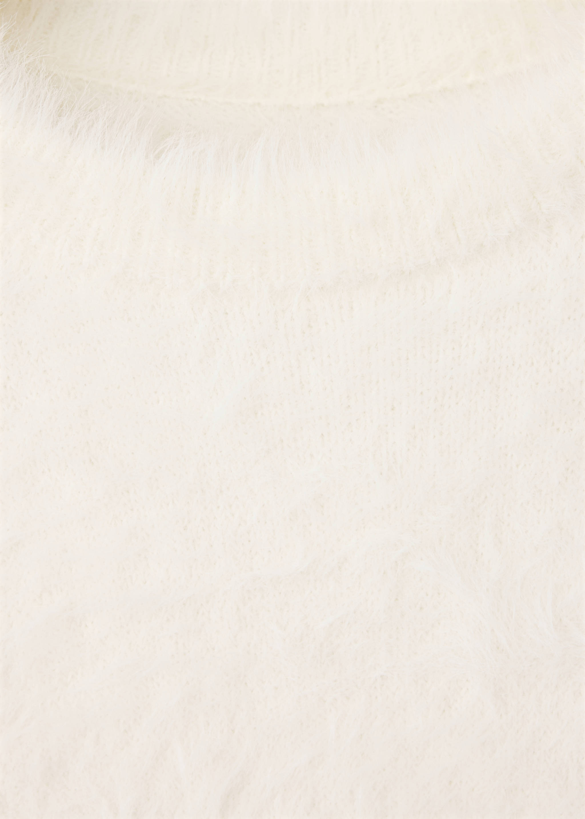 Close-up of a white textured knit jumper.