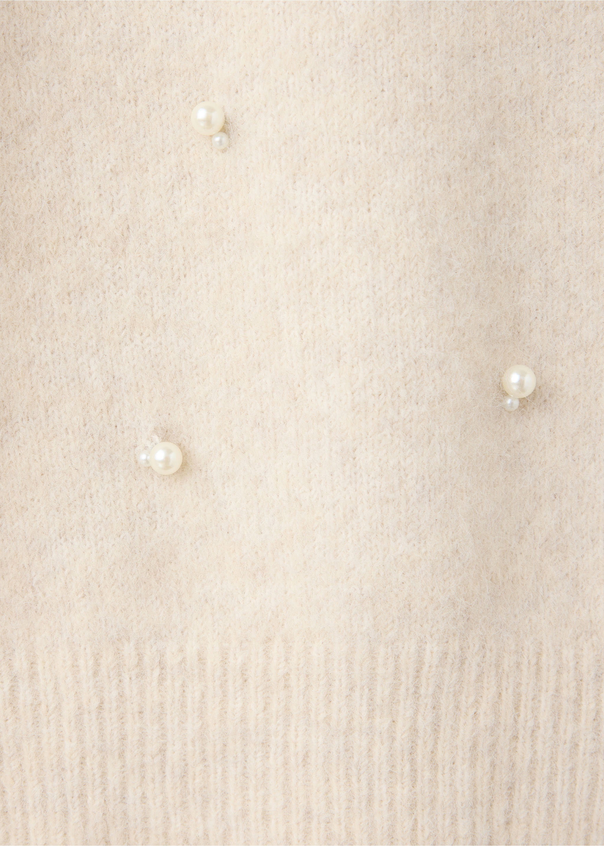 Close-up of a cream knit jersey with fuzzy texture and pearl bead details., Ecru. Ref: 37007805-00.