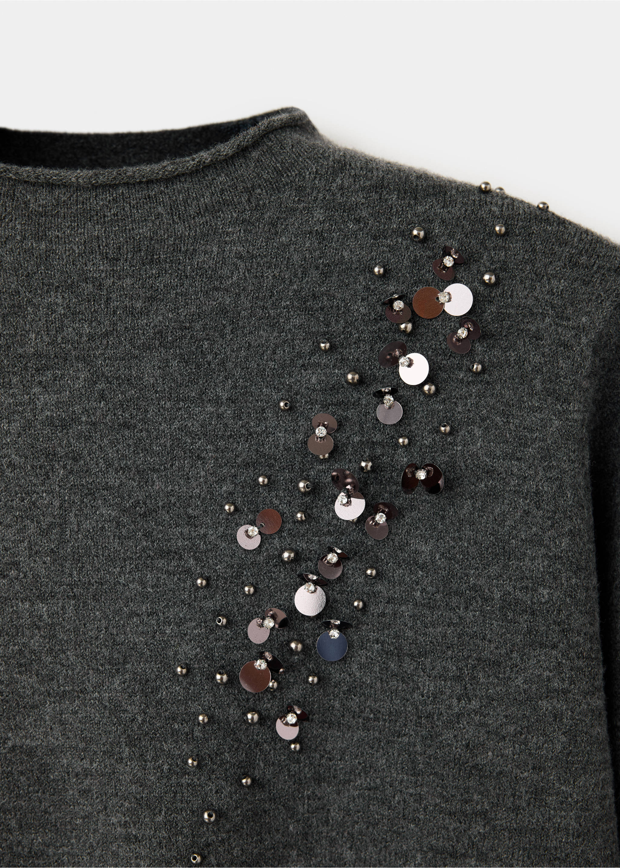 Dark grey knit jersey close-up featuring a diagonal cluster of metallic beads, sequins, and rhinestones., Charcoal. Ref: 37007807-00.