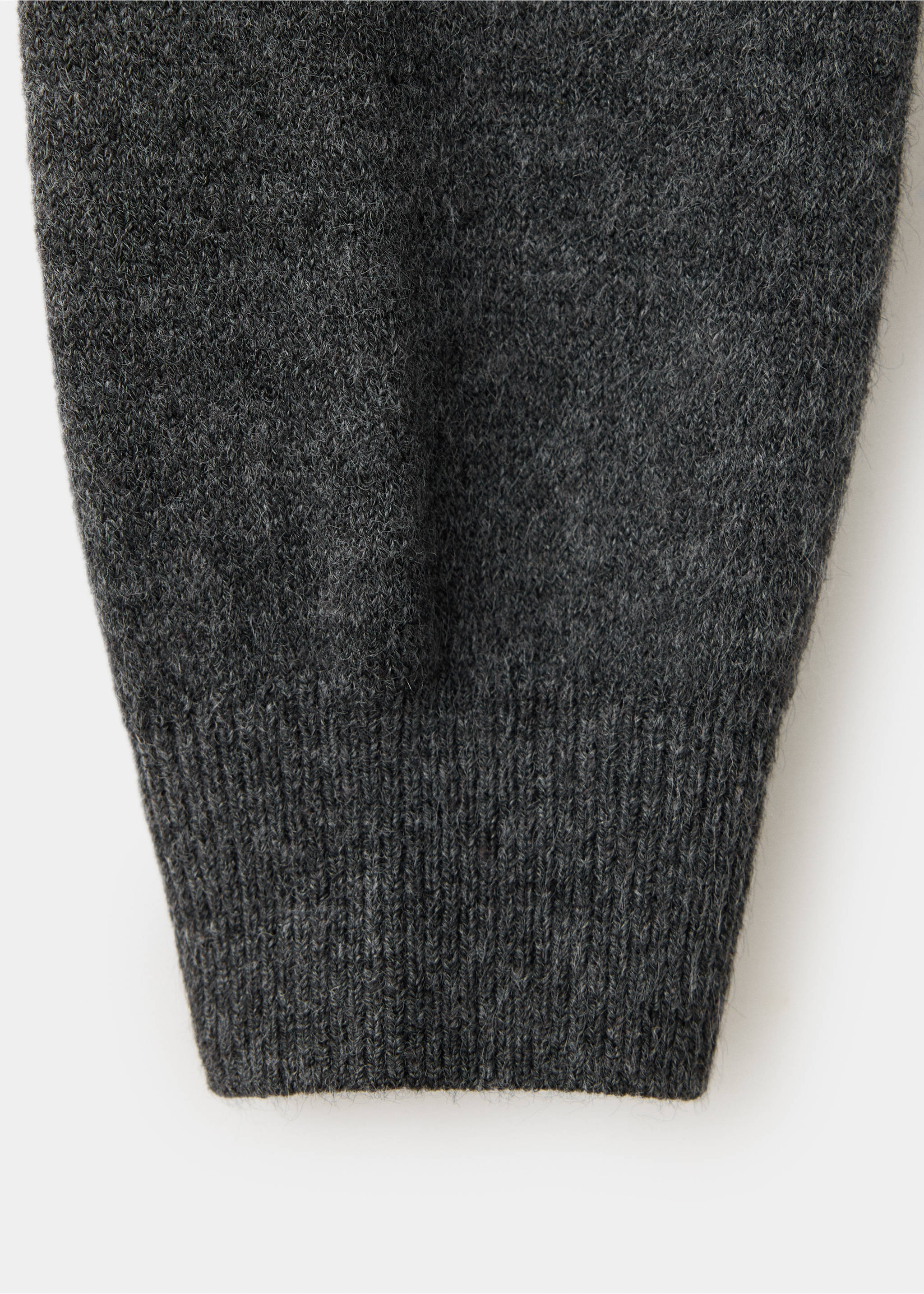 Close-up of a dark grey knitted sweater sleeve with a ribbed cuff., Charcoal. Ref: 37007807-00.