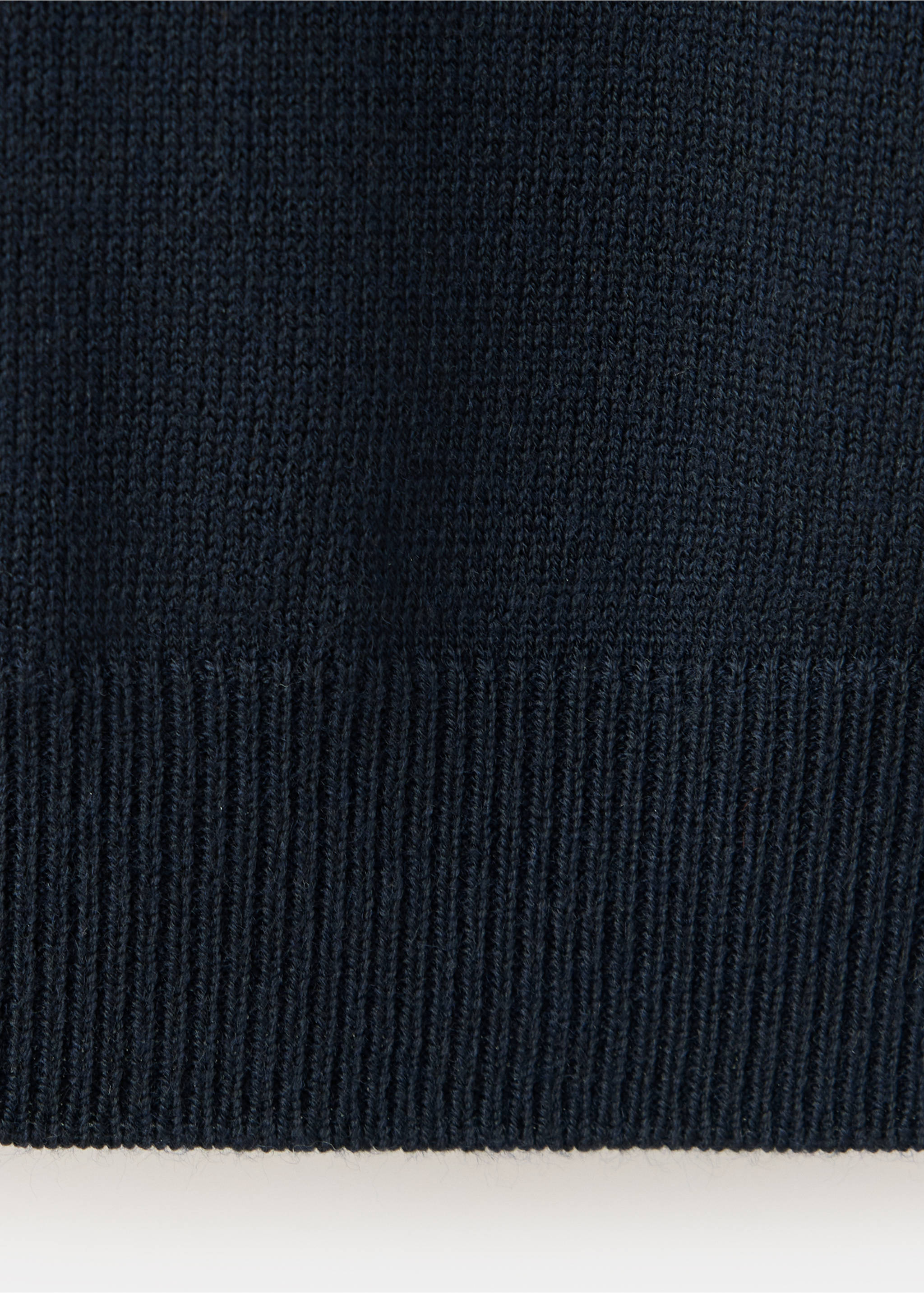 Close-up of a dark blue sweater knit fabric showing the ribbed hem., Navy. Ref: 37007808-00.