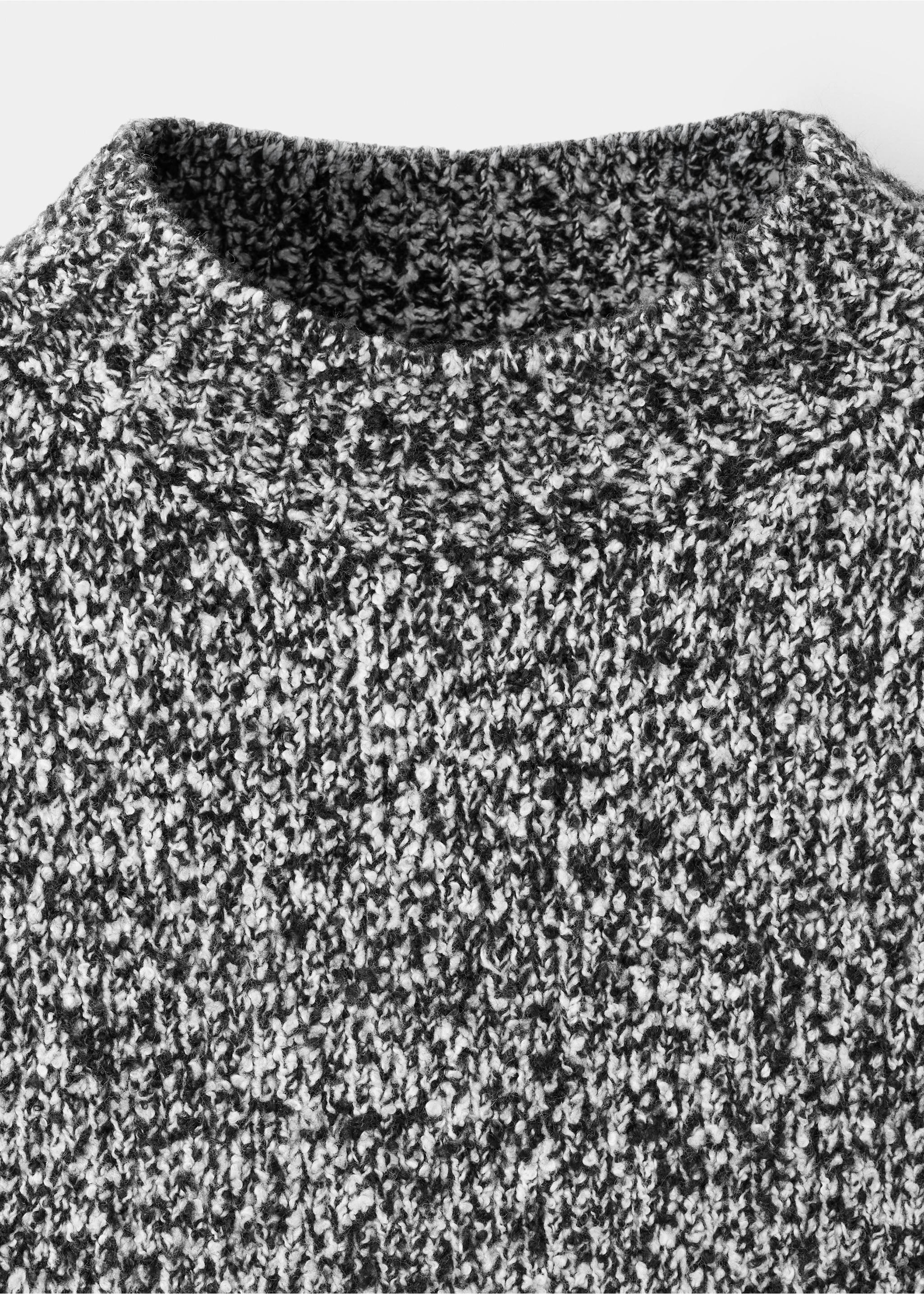 Close-up of a black and white marled knit sweater with a ribbed neckline., Medium Heather Grey. Ref: 37007811-00.