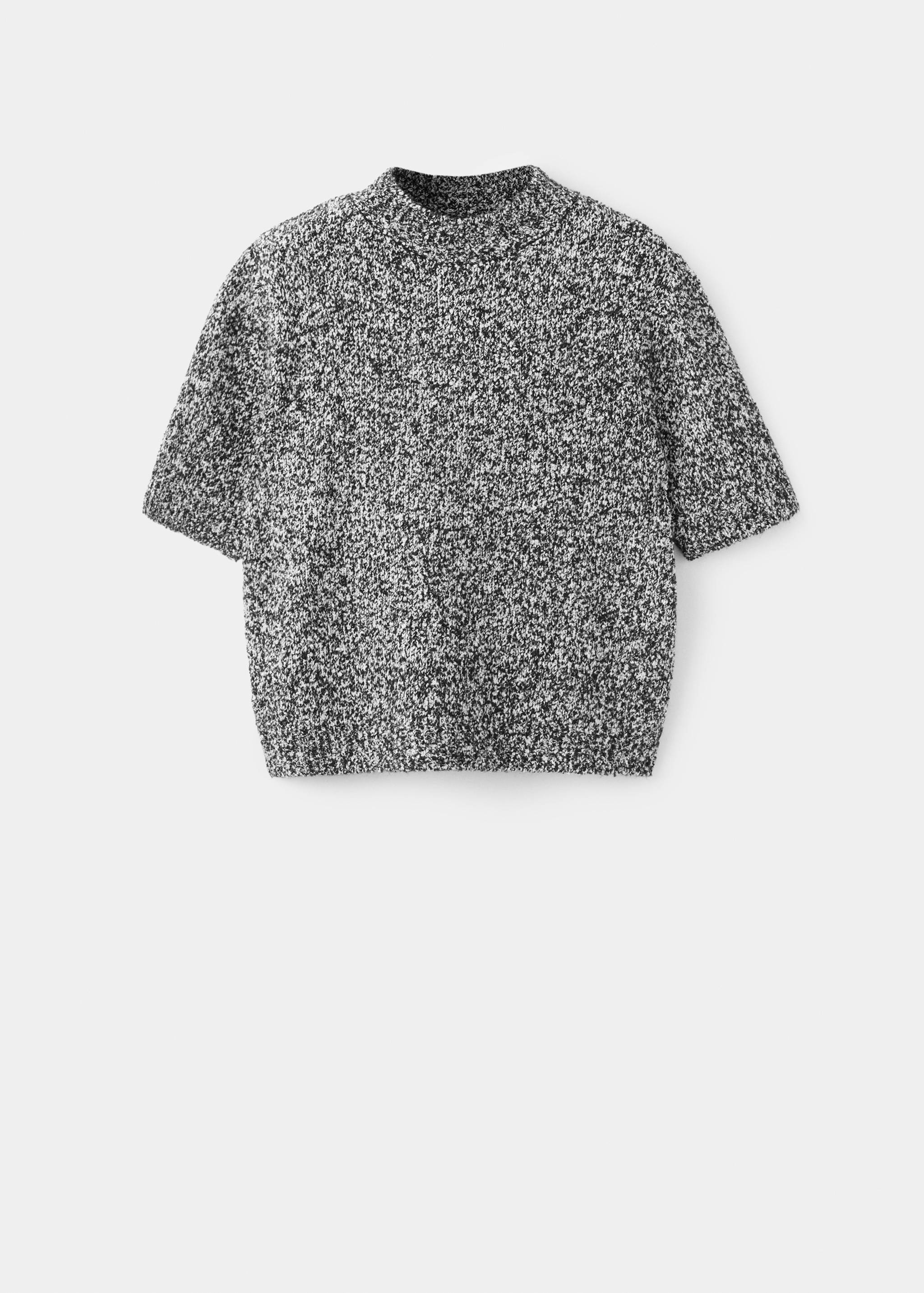 Black and white speckled short-sleeved knit sweater with a high neck.