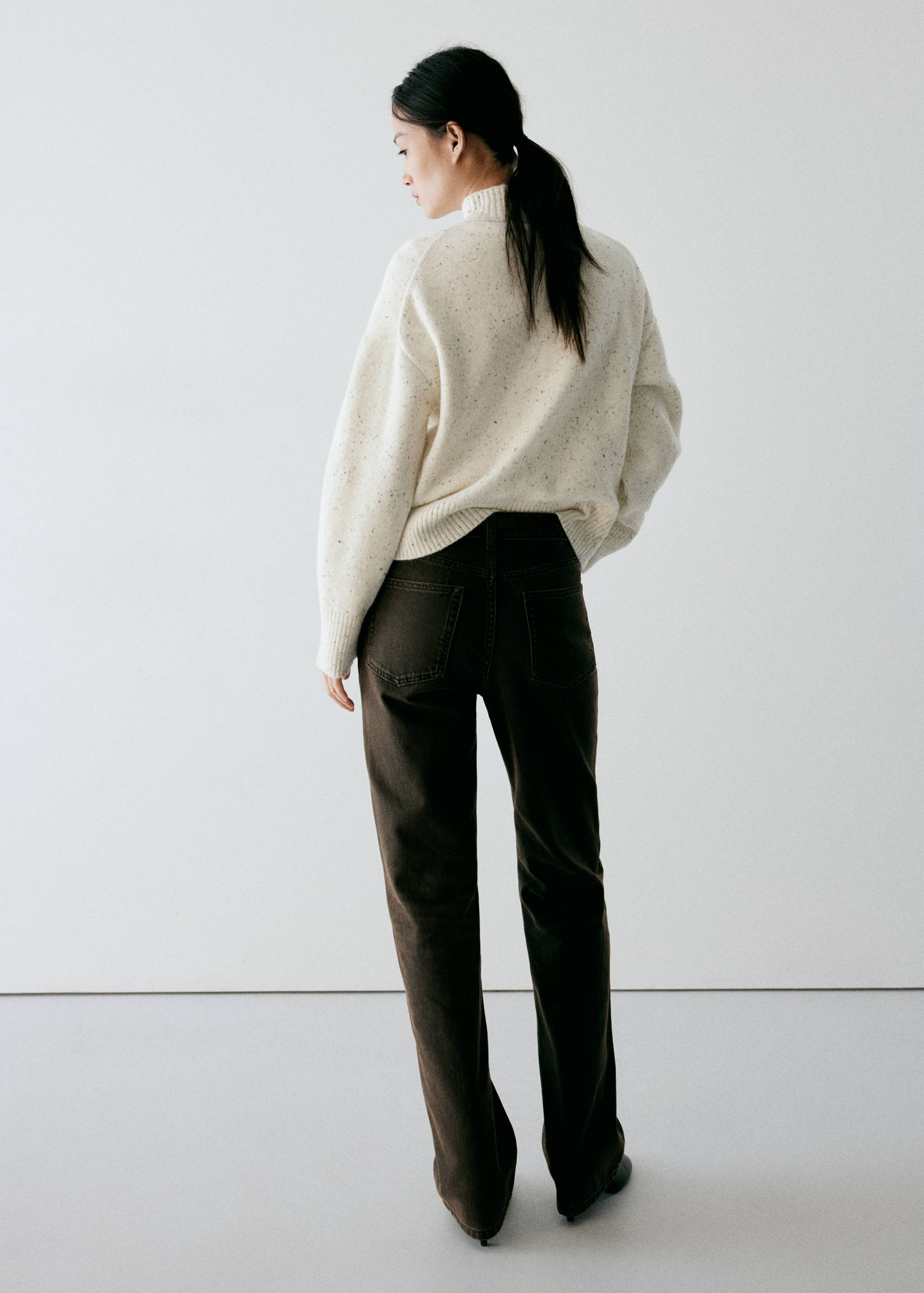 Off-white speckled knit jumper with a high neck, shown from the back.