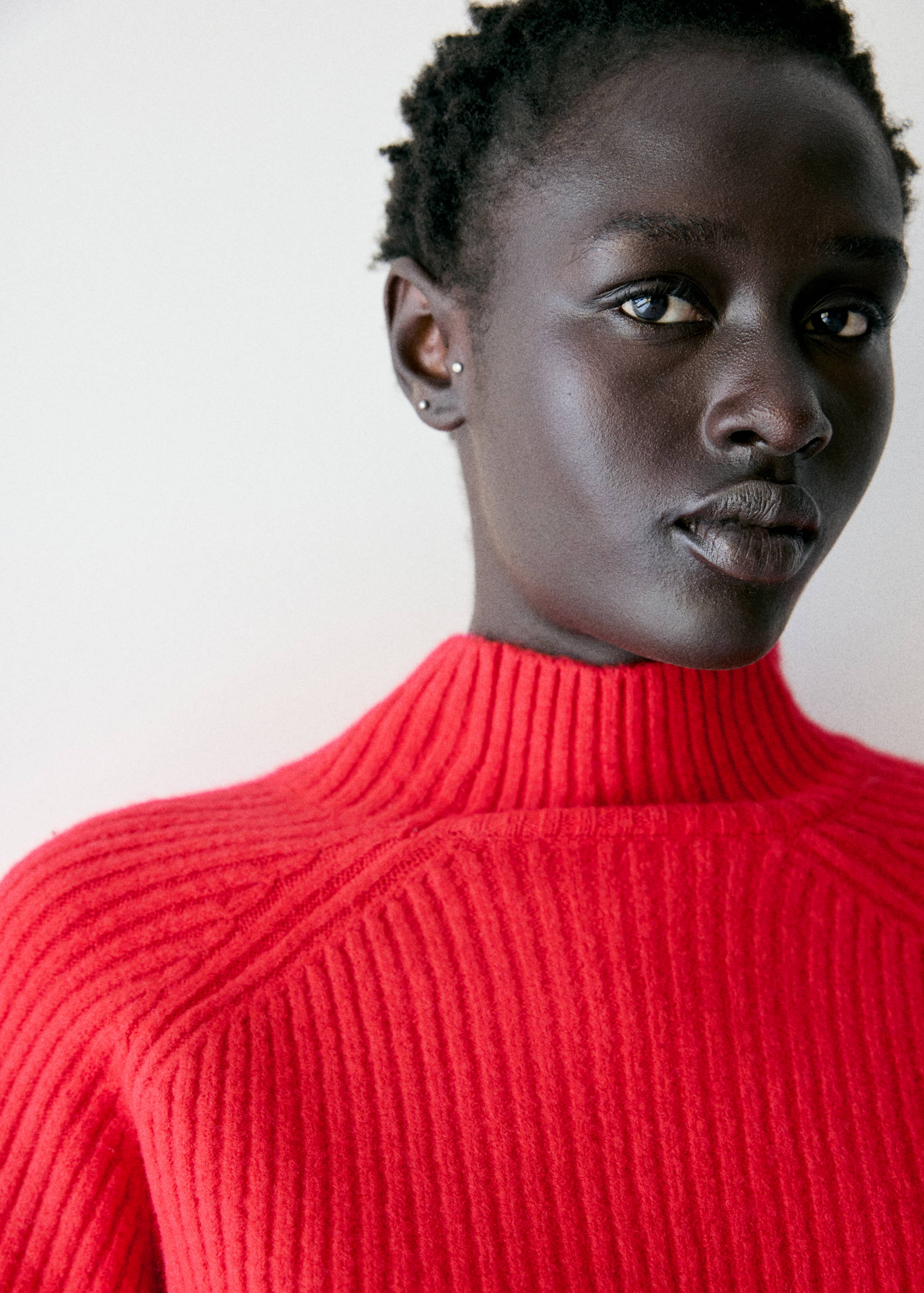 Close-up of a red ribbed high-neck jersey.