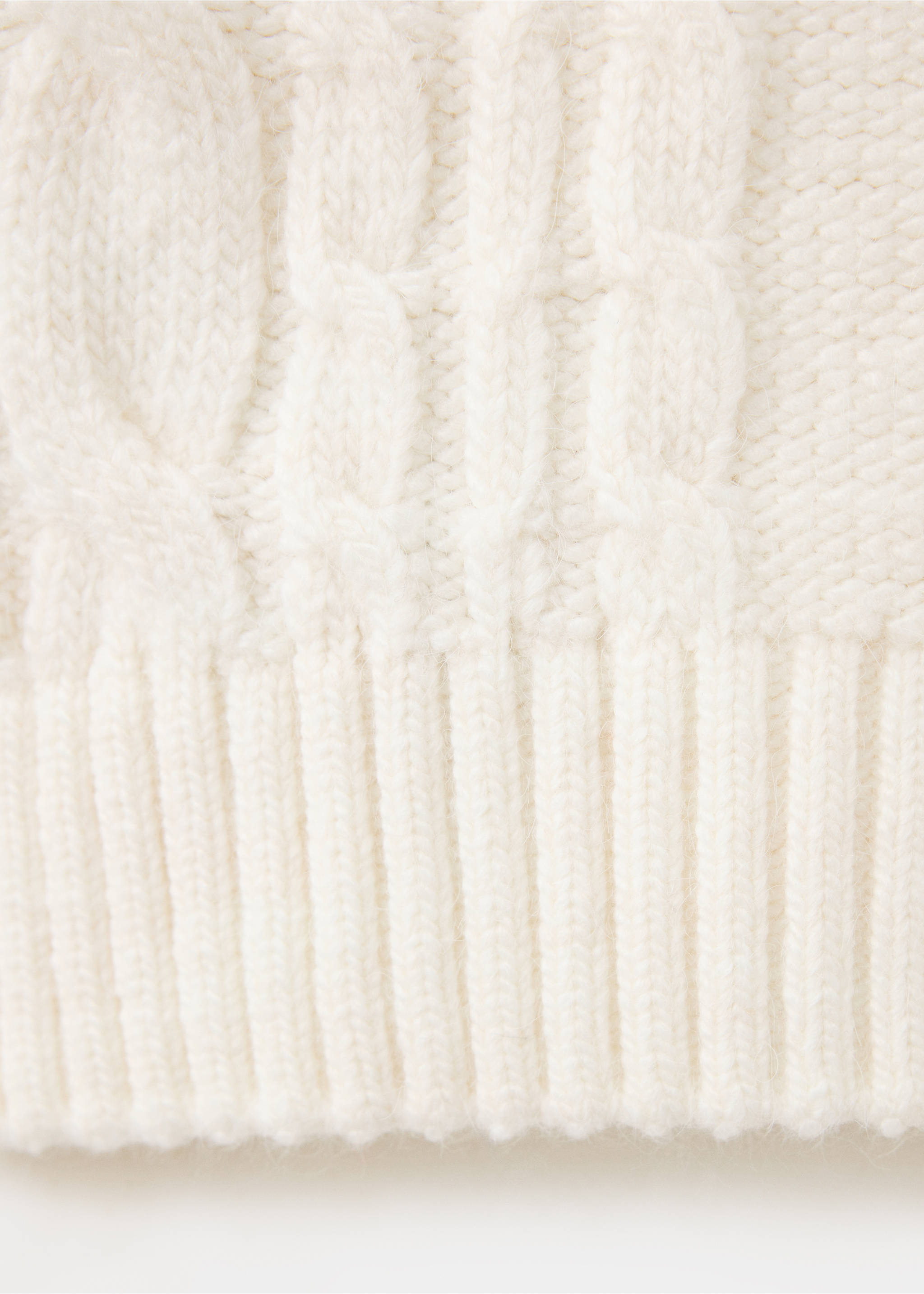 Close-up of a white cable-knit jumper showing the textured knit and ribbed hem., Ecru. Ref: 37007820-00.