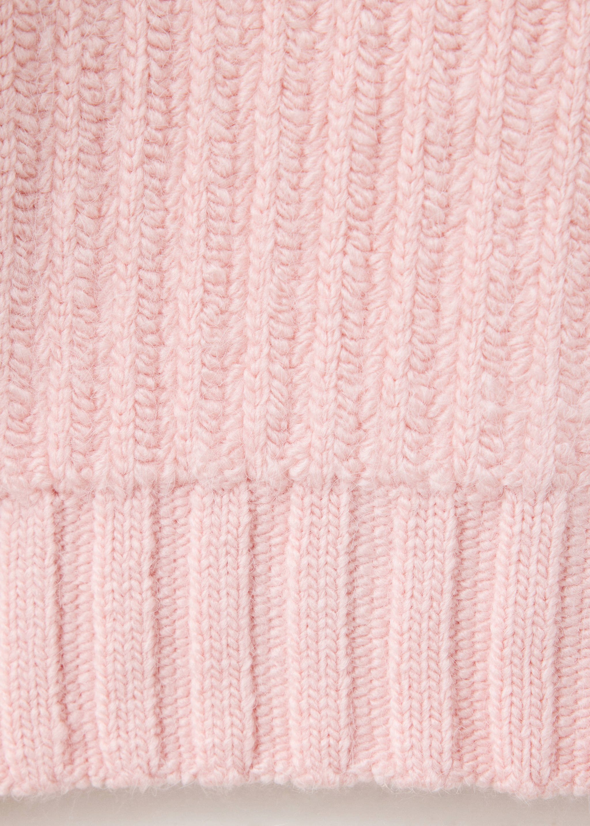 Pink knit jumper fabric detail showing ribbed texture.