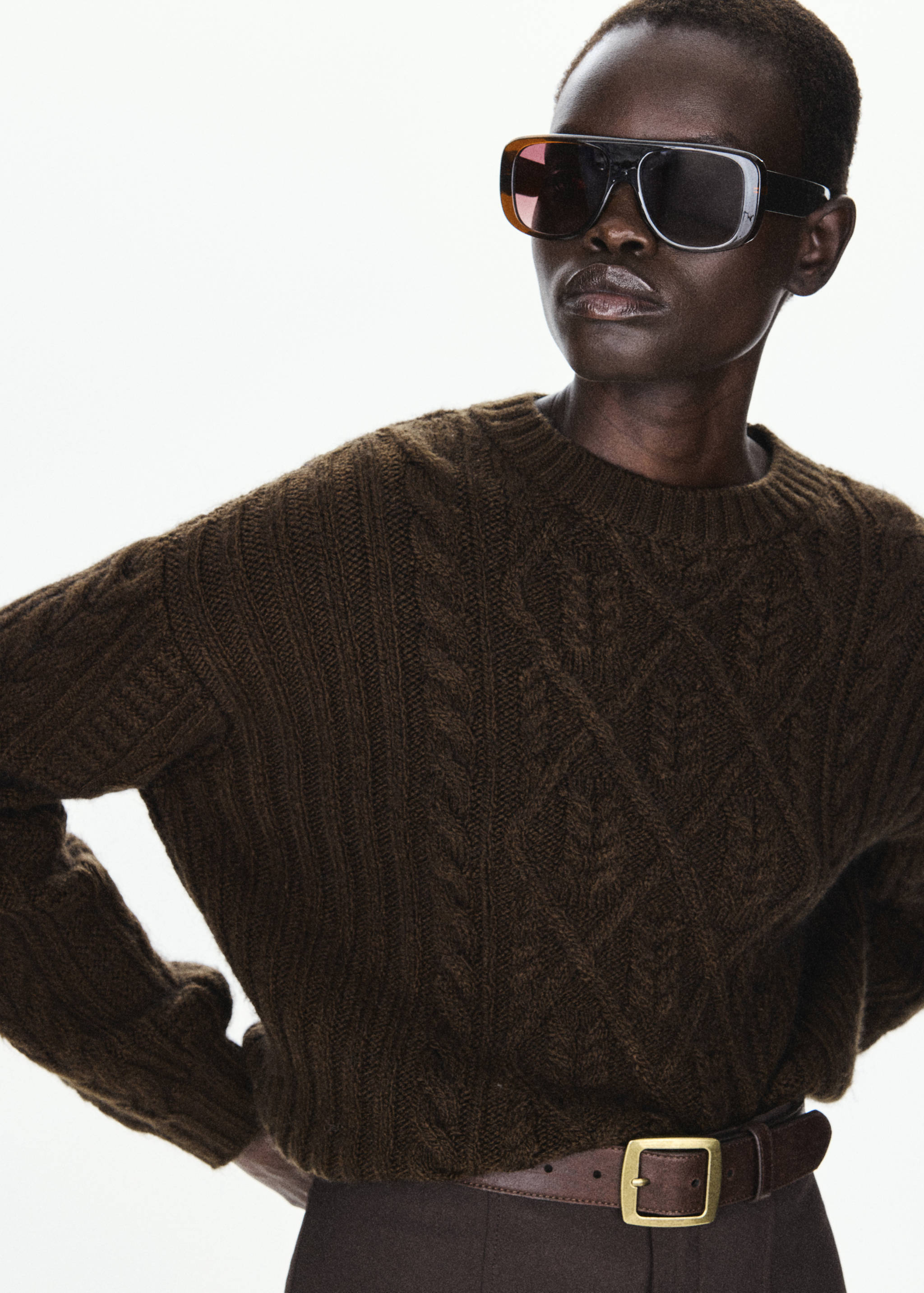 Dark brown cable-knit jumper with a crew neckline.