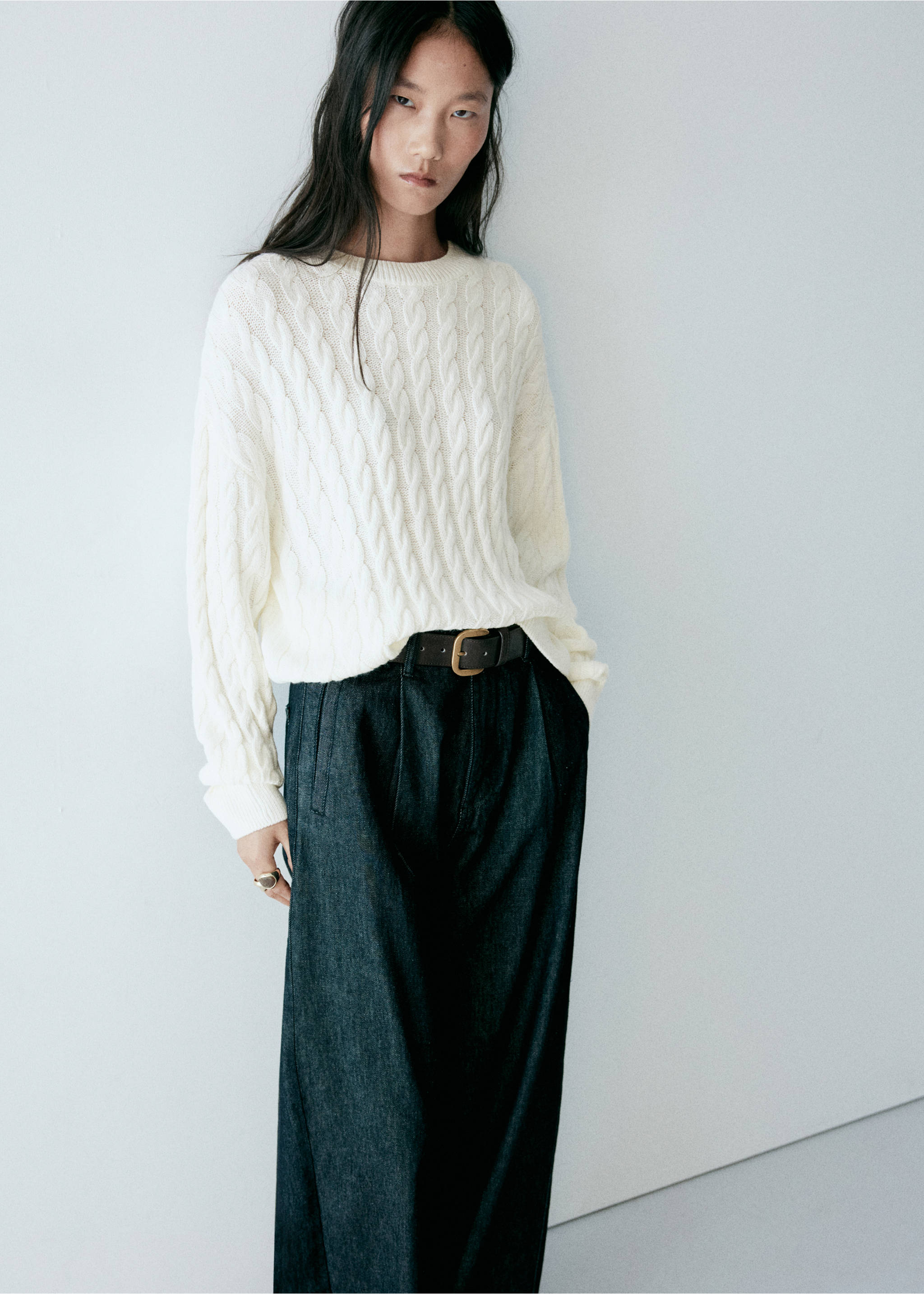 Off-white cable-knit sweater with a round neckline worn with dark denim trousers., Ecru. Ref: 37007825-00.