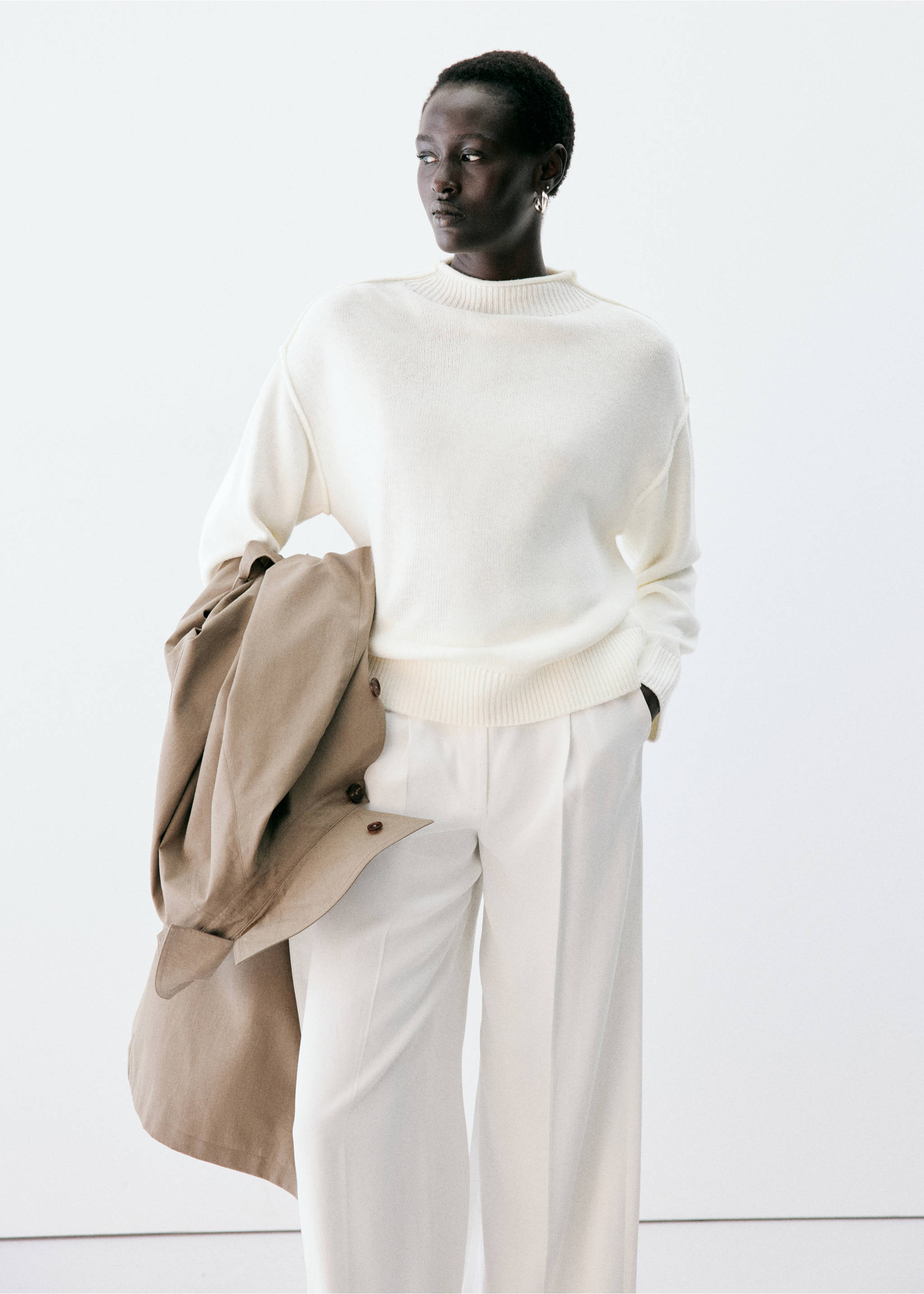 Off-white knitted jersey with a funnel neck, worn with white trousers., Ecru. Ref: 37007826-00.