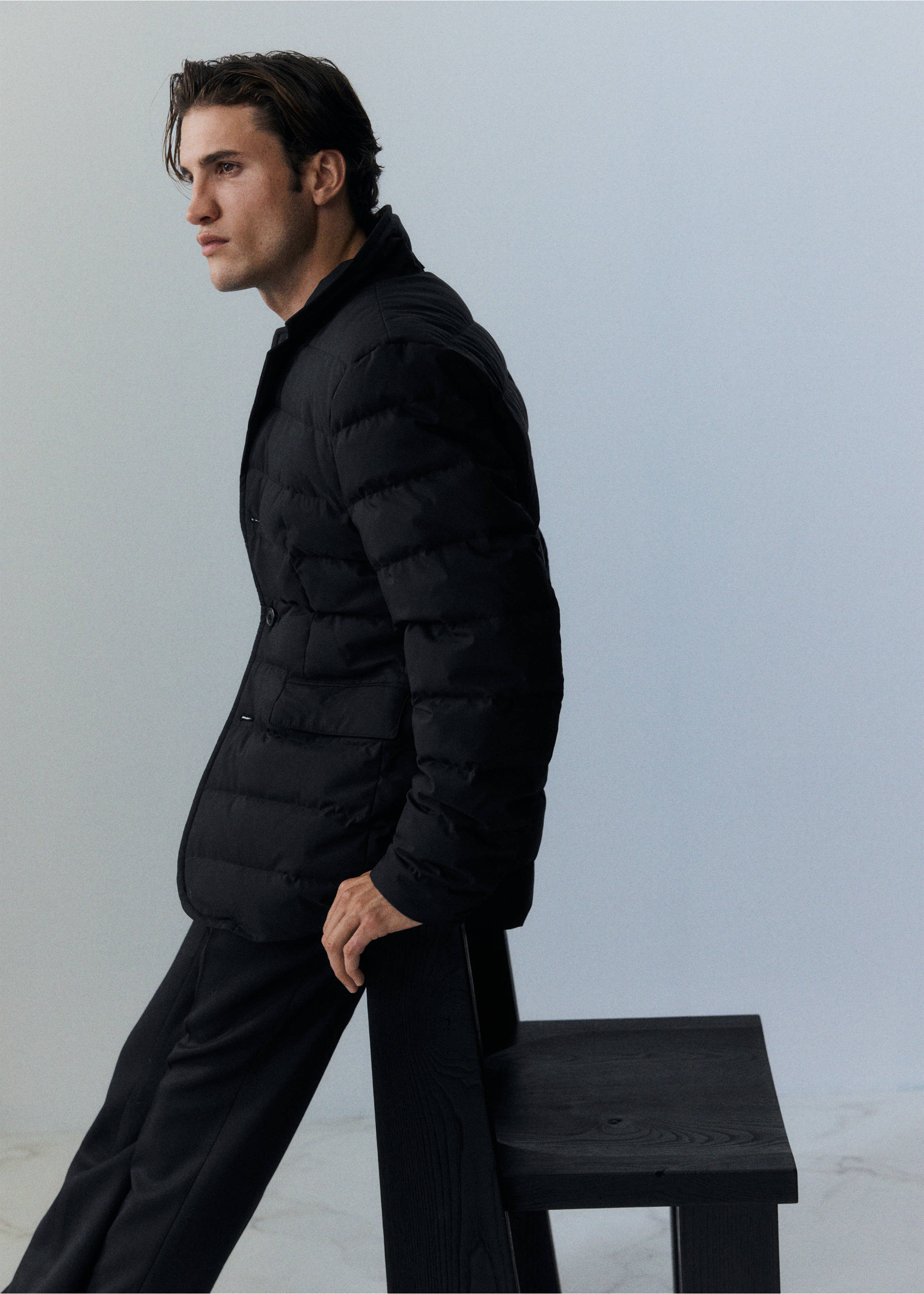Black quilted anorak with horizontal baffles, a button front, and flap pockets., Black. Ref: 37007886-00.