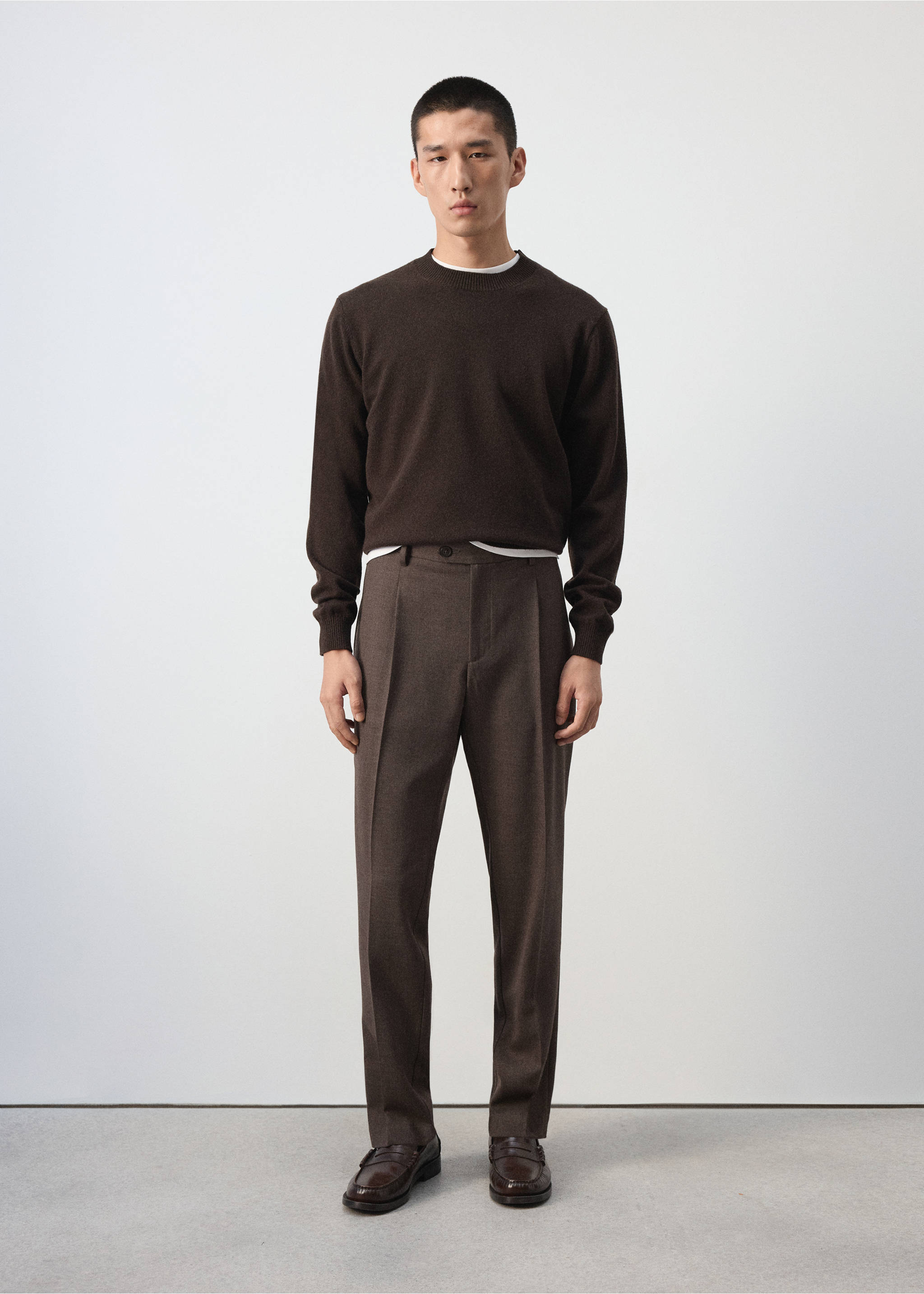 Brown trousers with pressed creases, worn with a dark brown crew-neck sweater., Chocolate. Ref: 37007888-00.