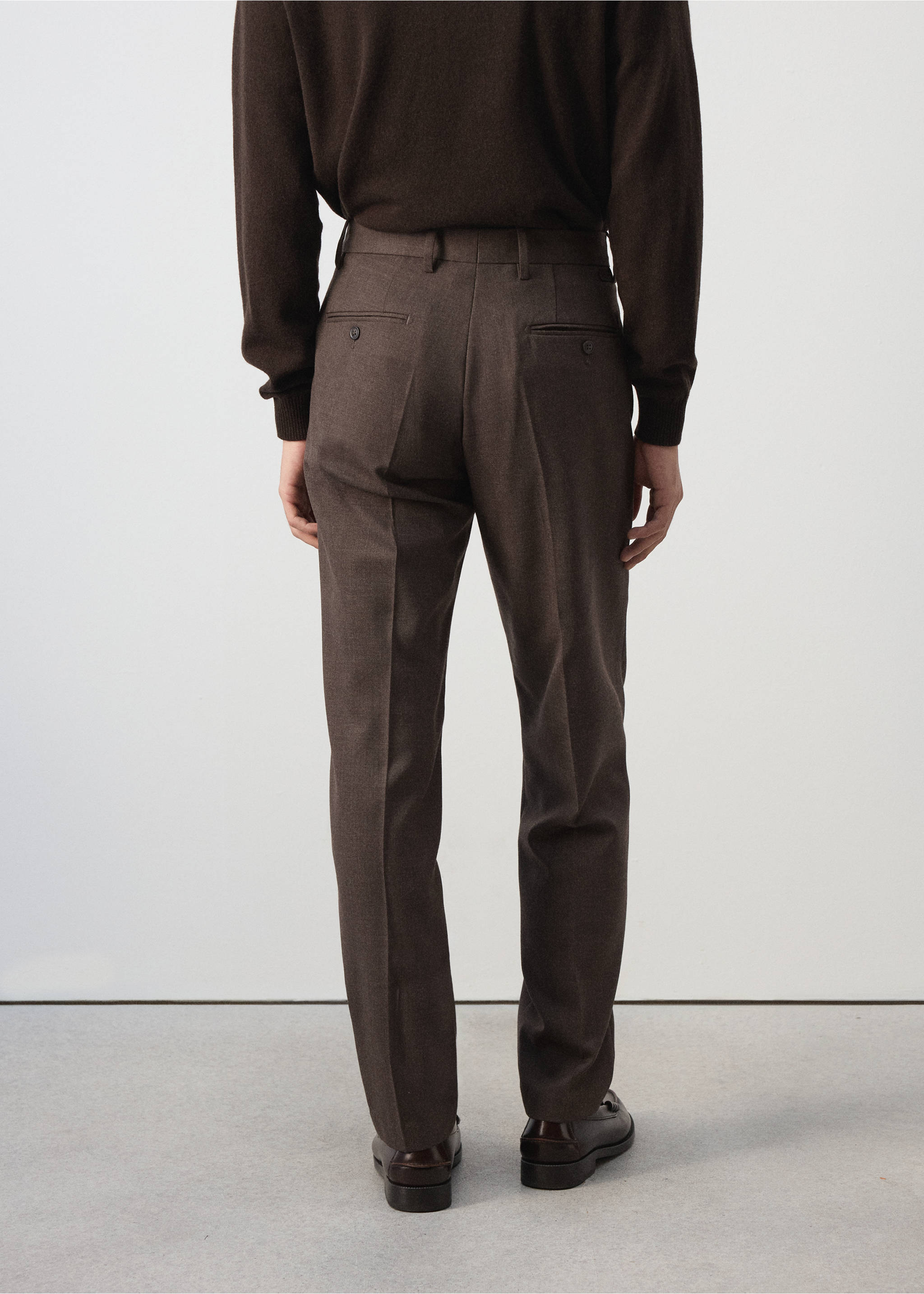 Dark brown trousers viewed from the back, featuring belt loops and buttoned welt pockets., Chocolate. Ref: 37007888-00.