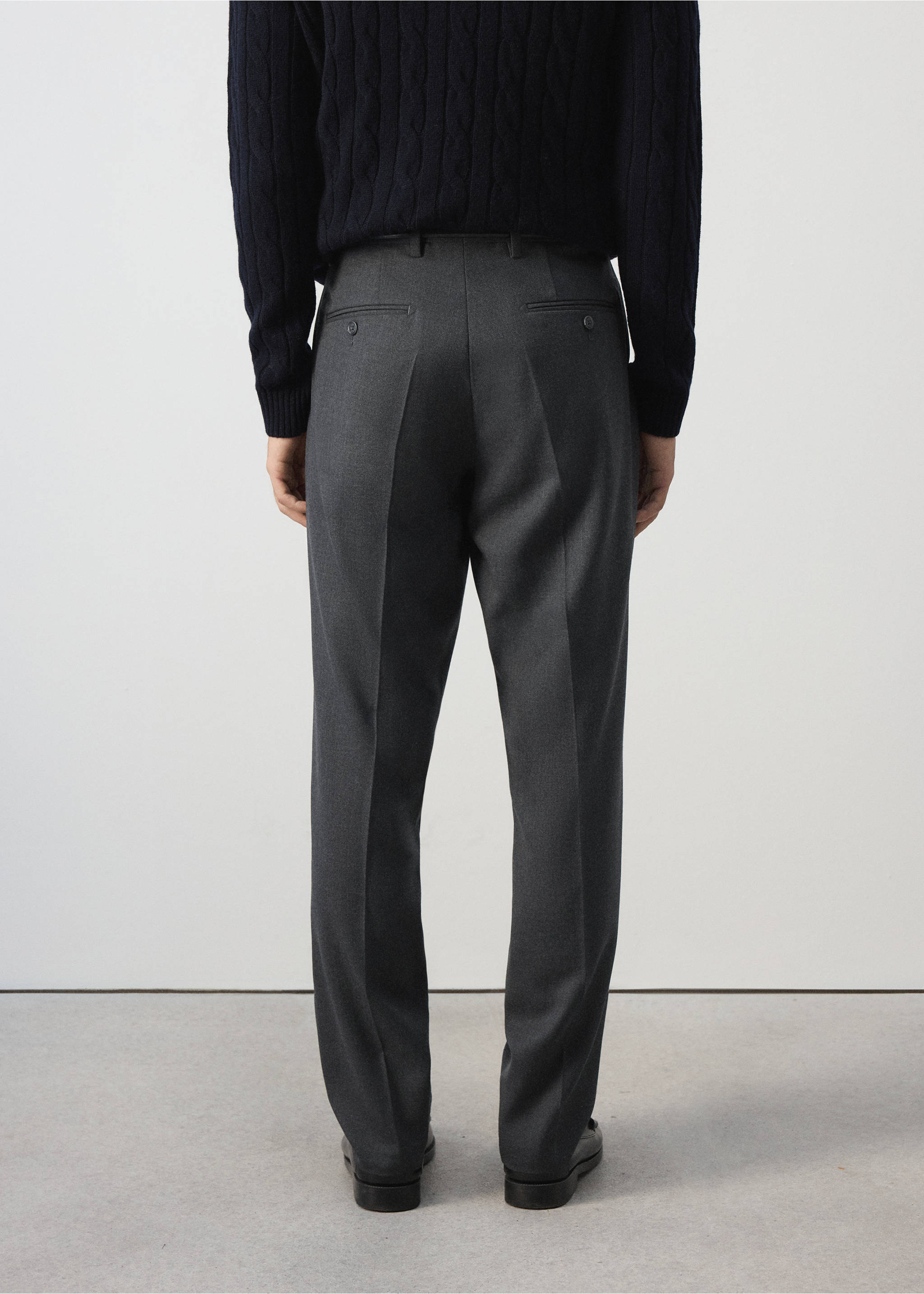 Dark grey trousers, back view, featuring a tailored straight fit with belt loops and buttoned welt pockets., Charcoal. Ref: 37007888-00.