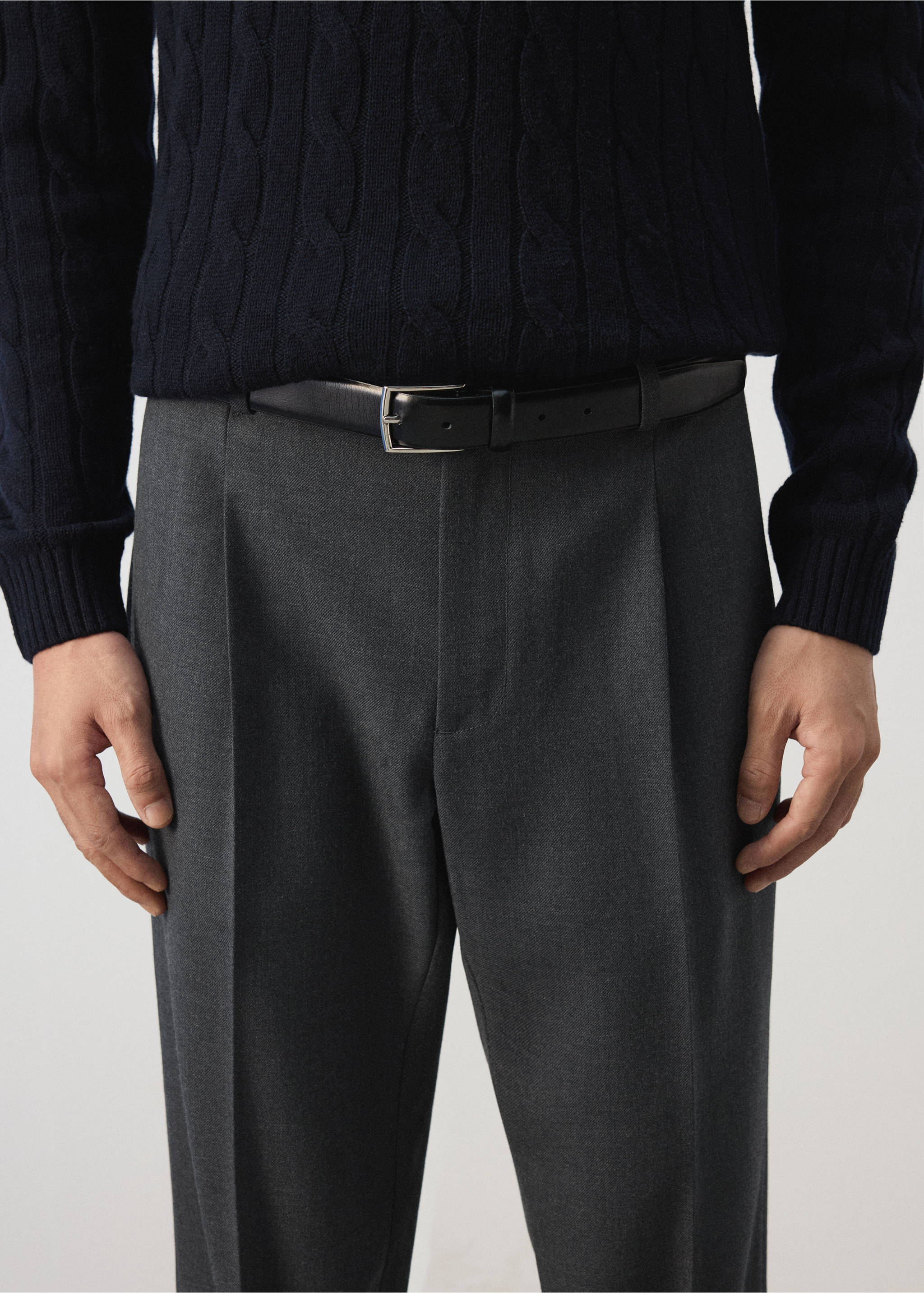 Dark grey pleated trousers with a black leather belt., Charcoal. Ref: 37007888-00.