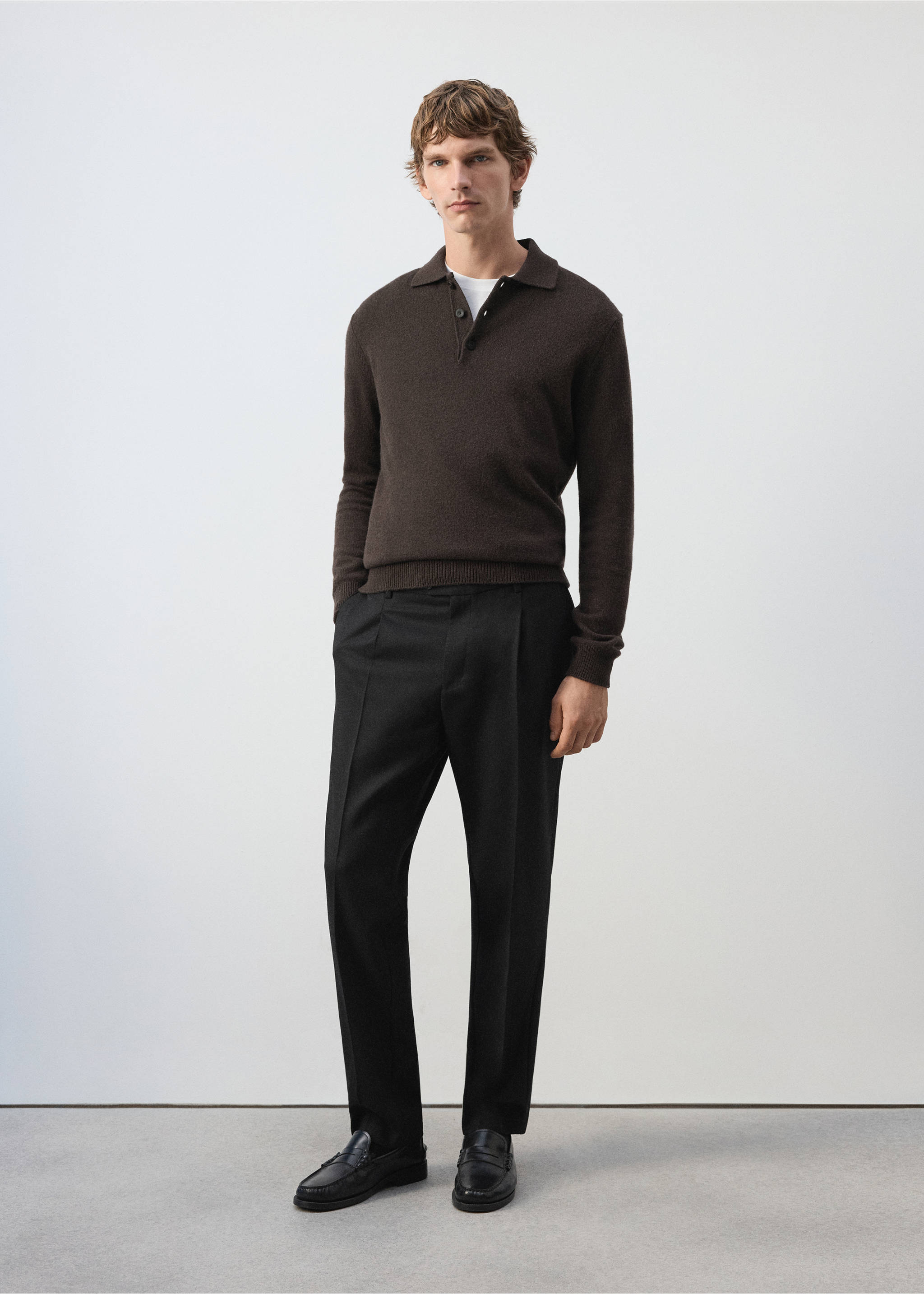 Black straight-leg trousers with front pleats, worn with a dark brown polo sweater., Black. Ref: 37007888-00.