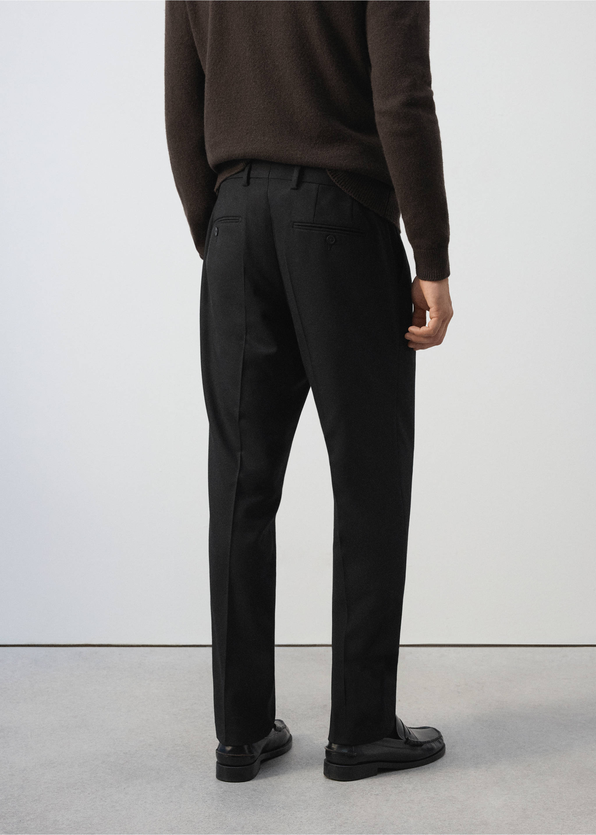 Black trousers shown from the back, paired with a dark brown knit sweater., Black. Ref: 37007888-00.