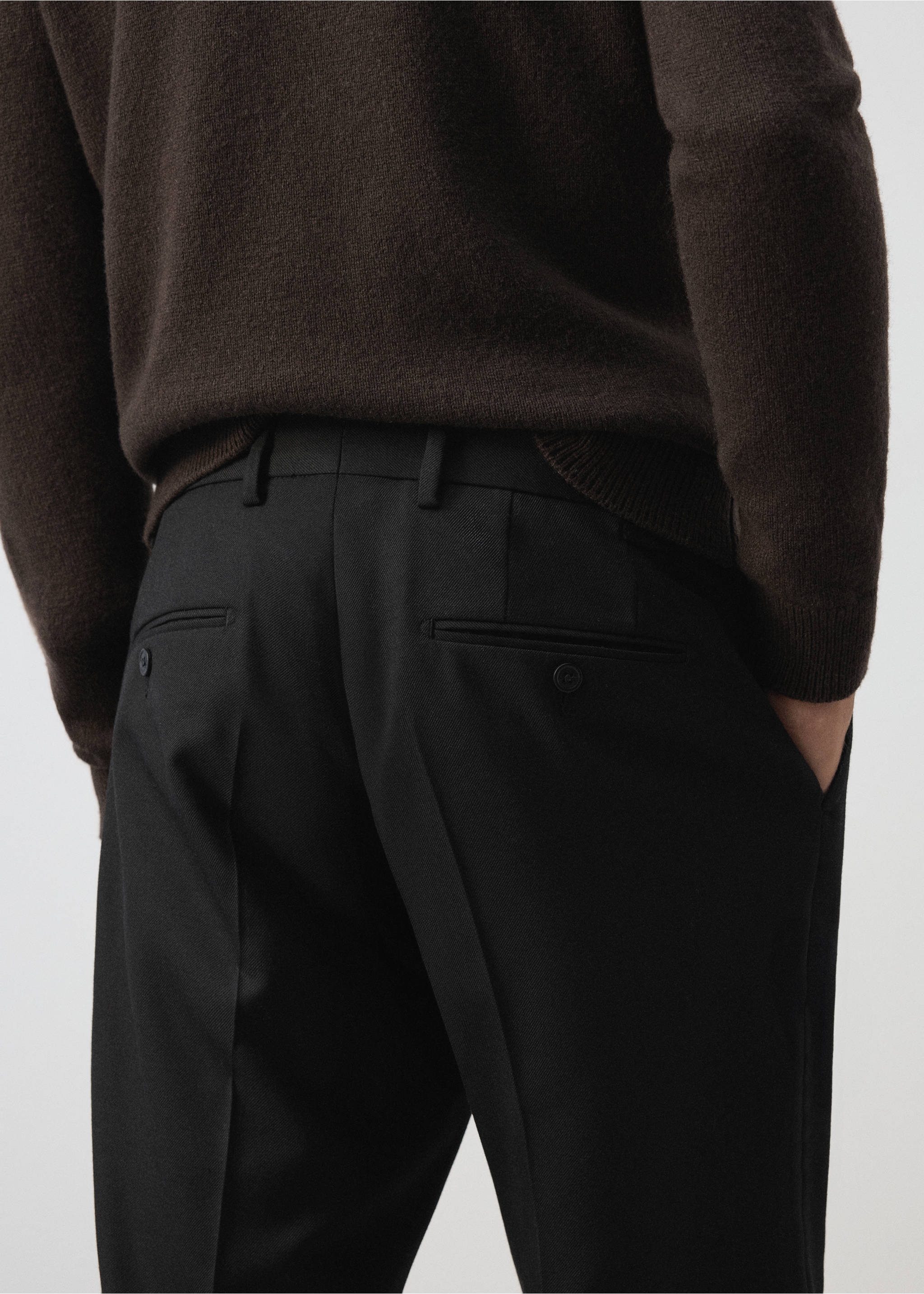 Black trousers featuring belt loops, creases, and welt back pockets, back view., Black. Ref: 37007888-00.