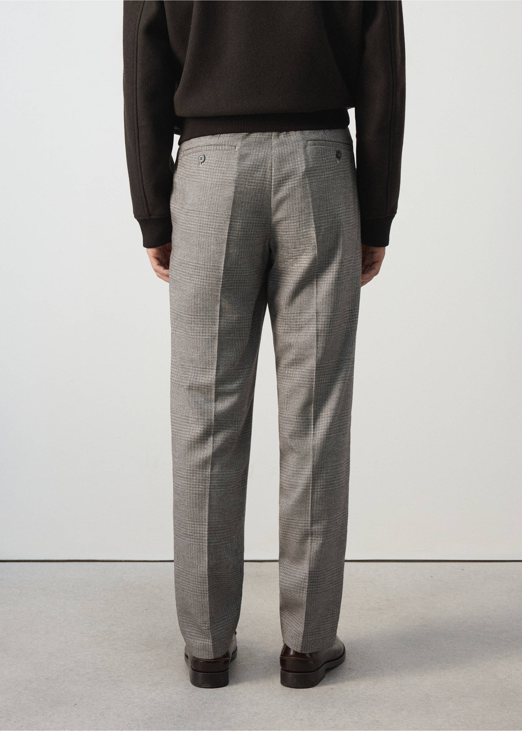 Grey check trousers shown from the back, featuring rear buttoned welt pockets., Beige. Ref: 37007890-00.