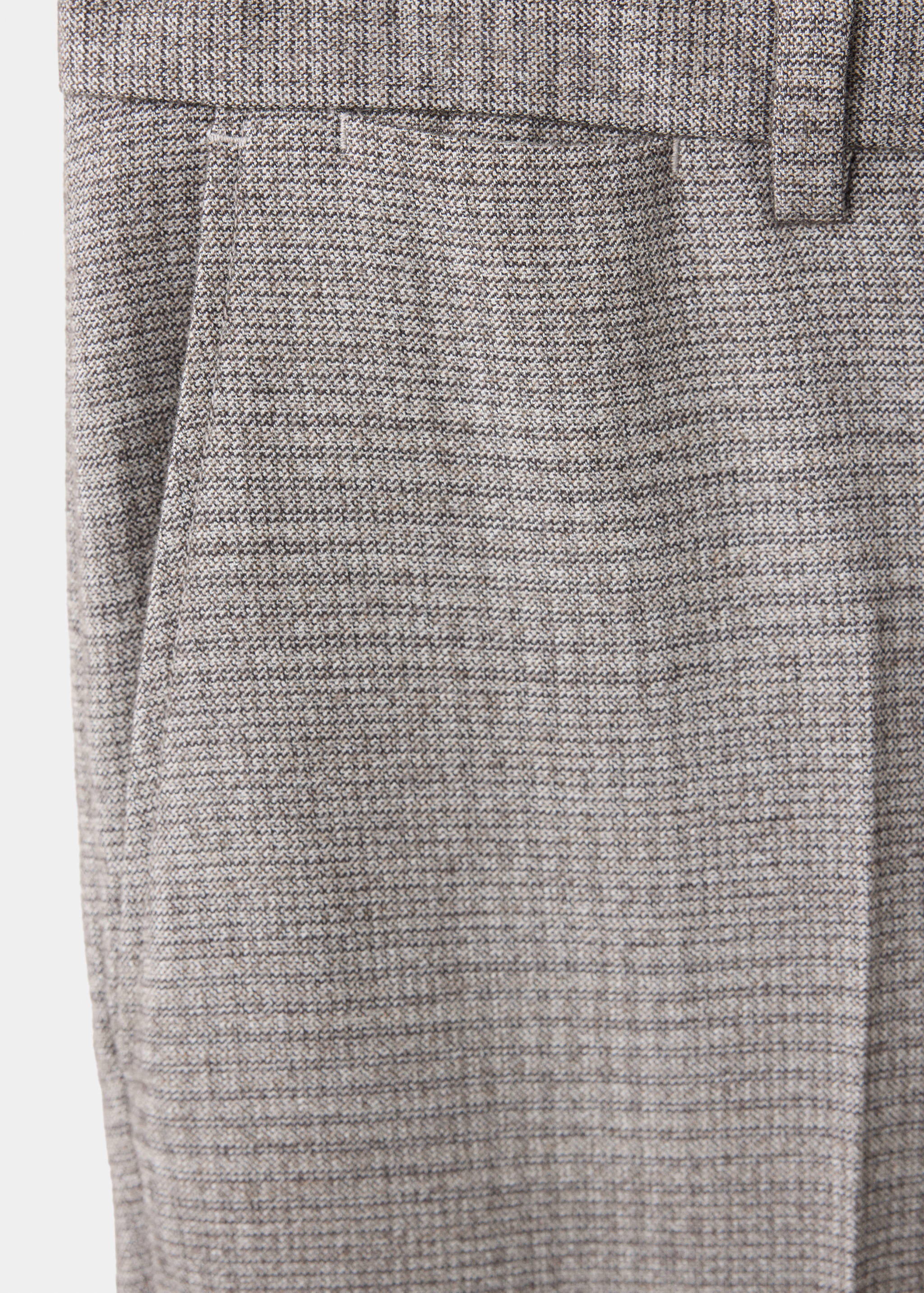 Brown patterned trousers fabric detail