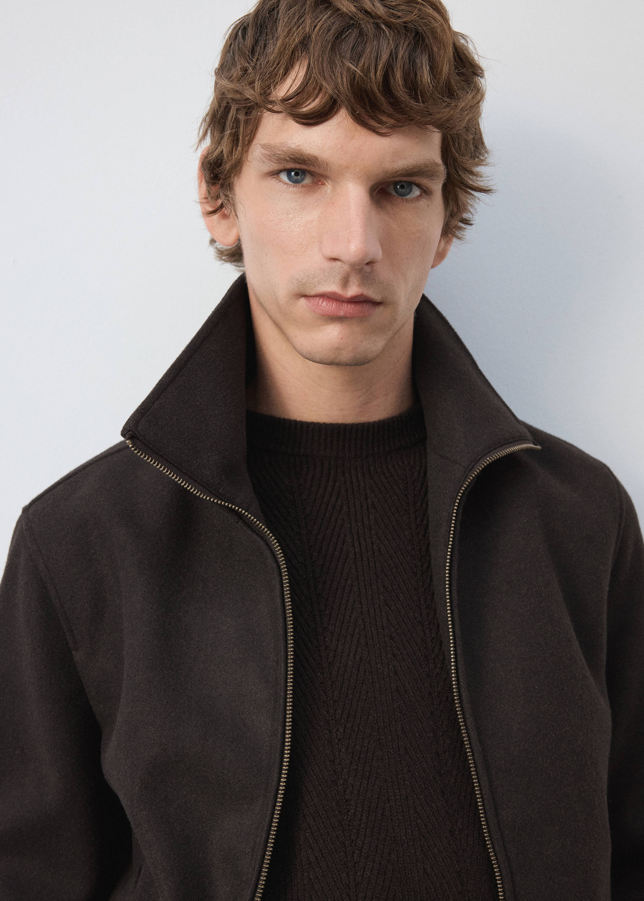 Dark brown zip-up jacket with a high collar.