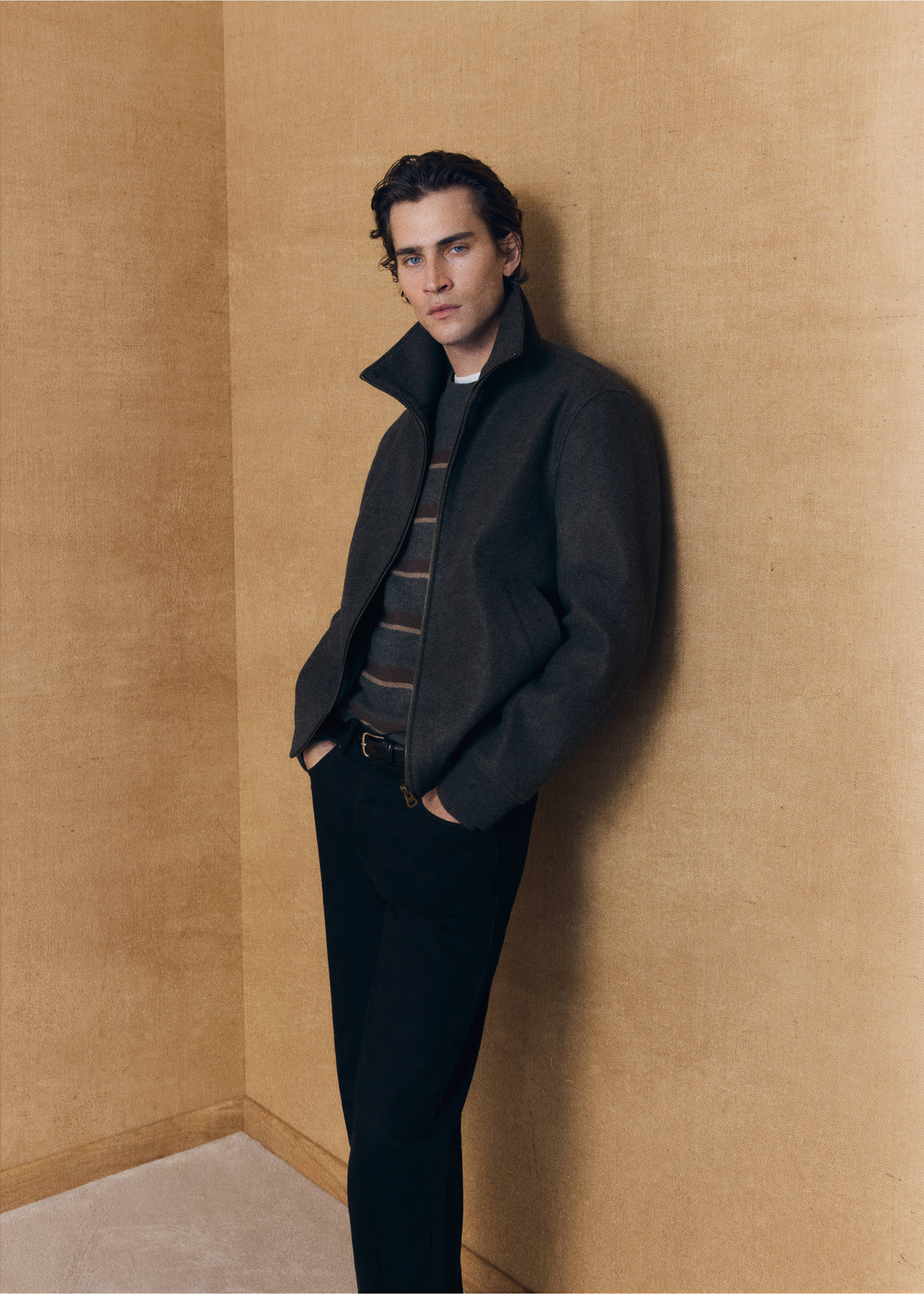 Dark grey jacket with a stand collar, worn over a striped sweater and dark trousers., Dark Heather Grey. Ref: 37007892-00.