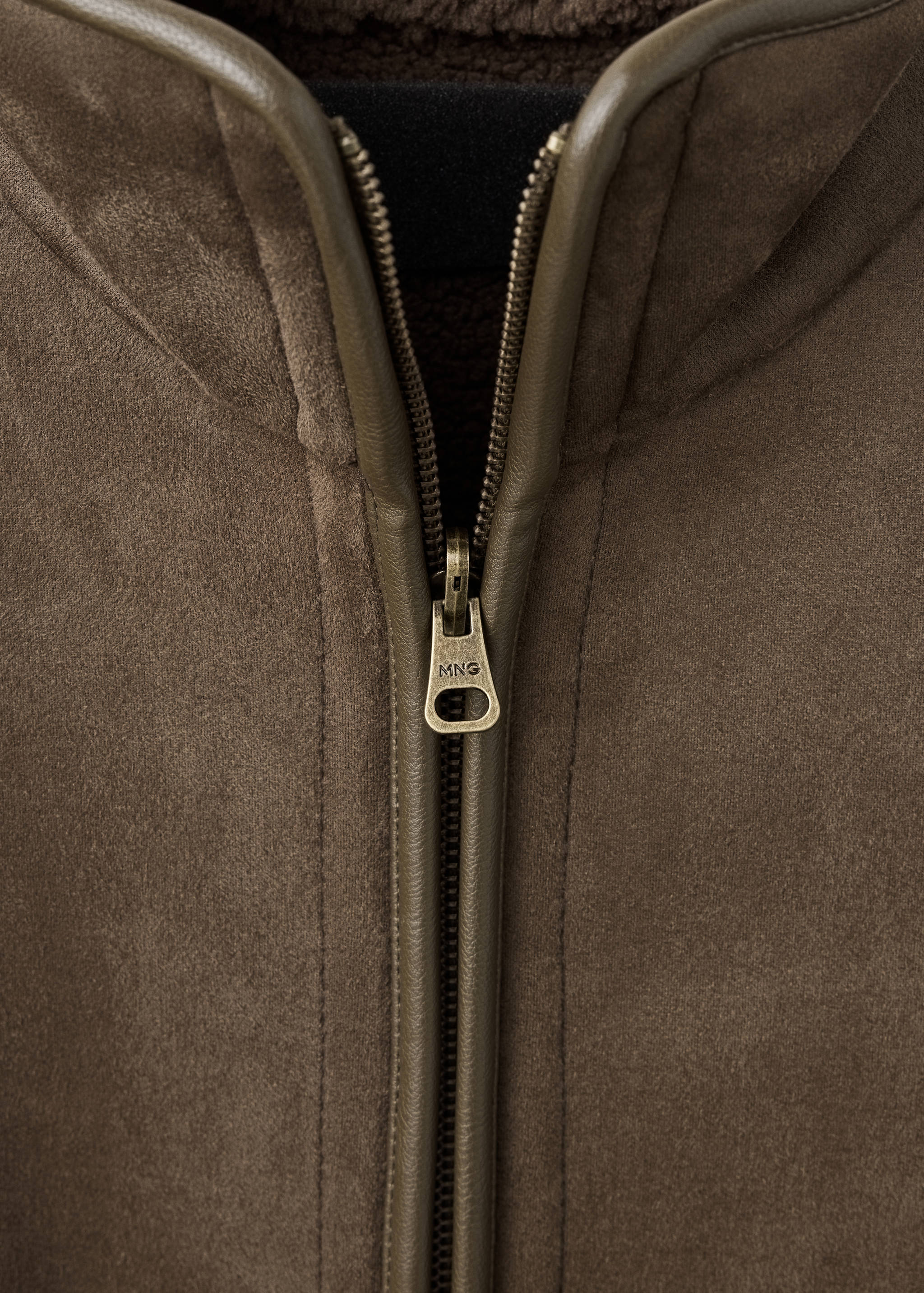 Close-up of brown faux-suede jacket showing zipper and faux-shearling collar.