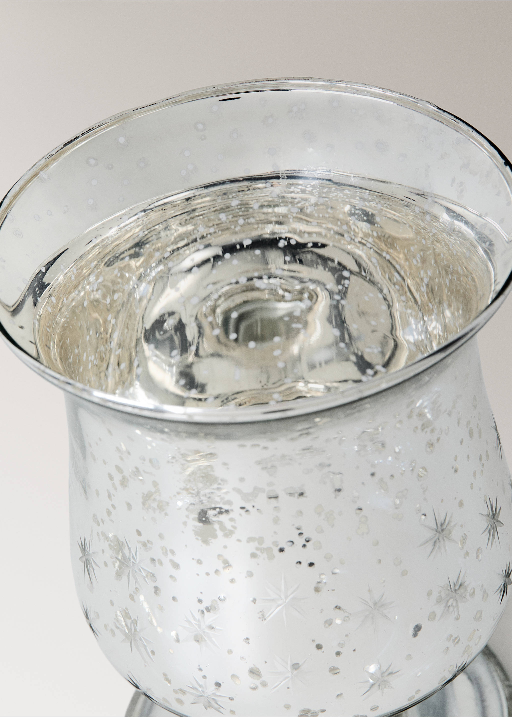 Close-up of a silver glass candle holder with a speckled star pattern., Silver. Ref: 37007899-00.