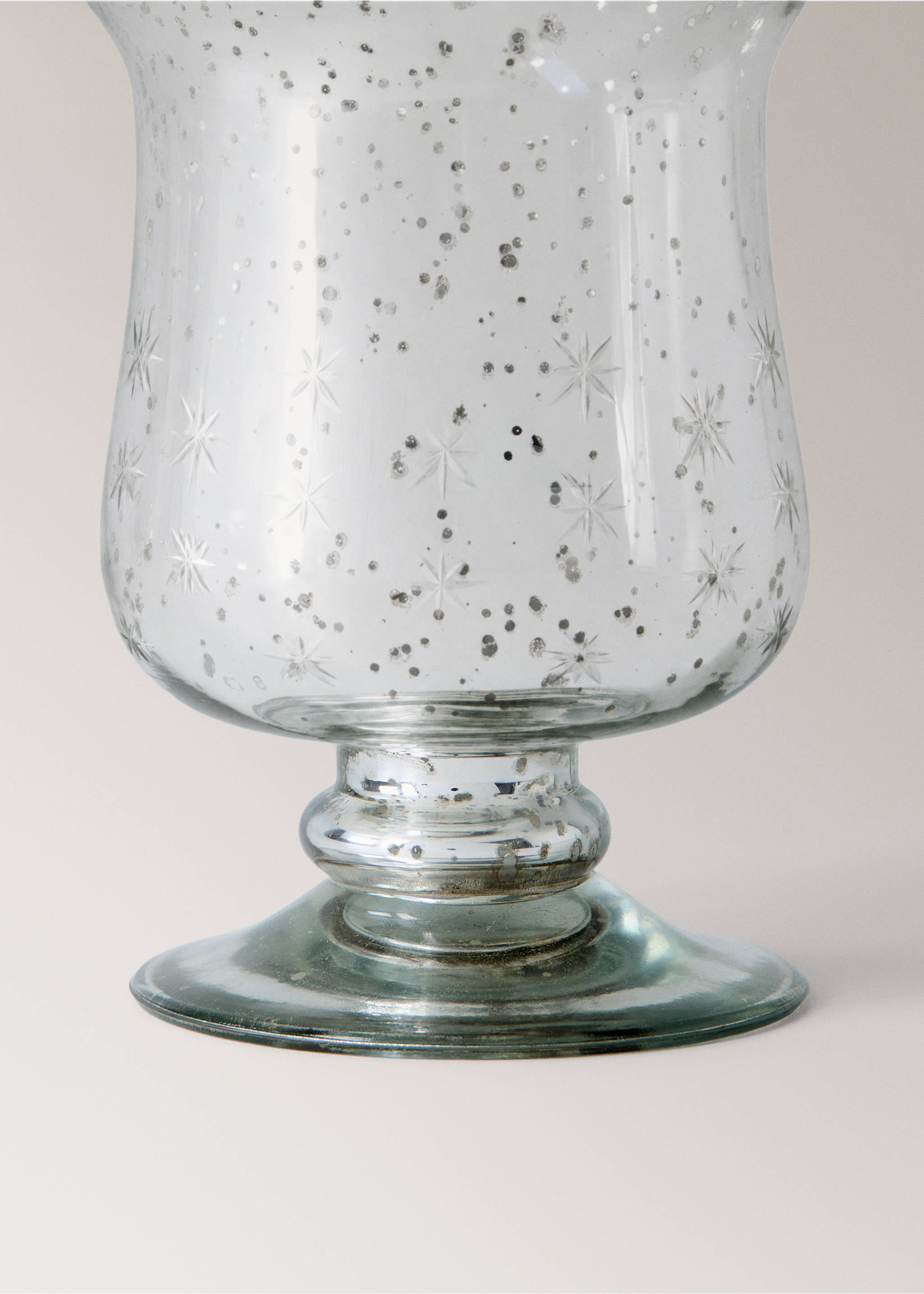 Close-up of a glass candle holder with an antique mercury finish and starburst patterns., Silver. Ref: 37007899-00.