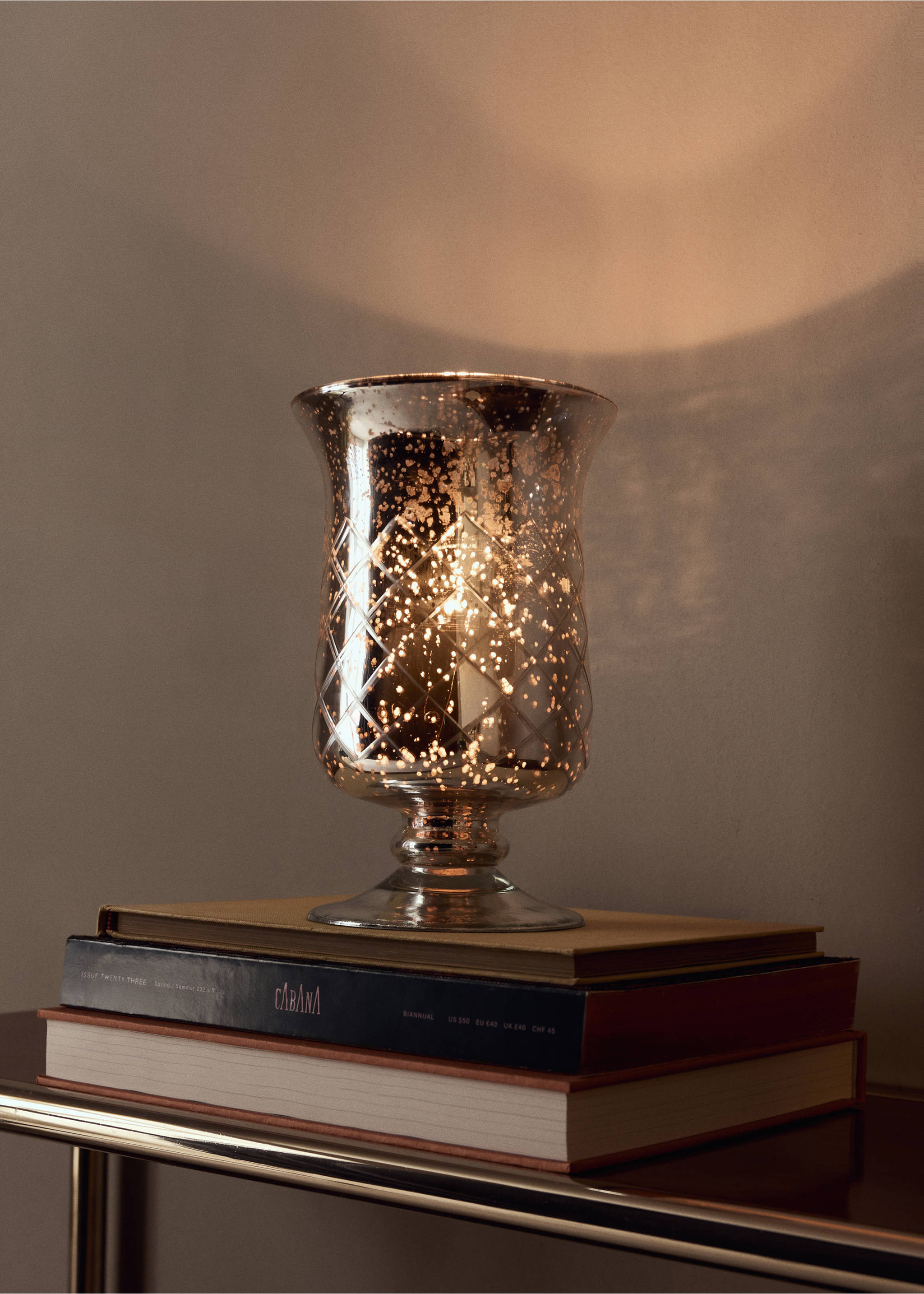 Decorative mercury glass candle holder with a diamond lattice pattern on books., Silver. Ref: 37007900-00.