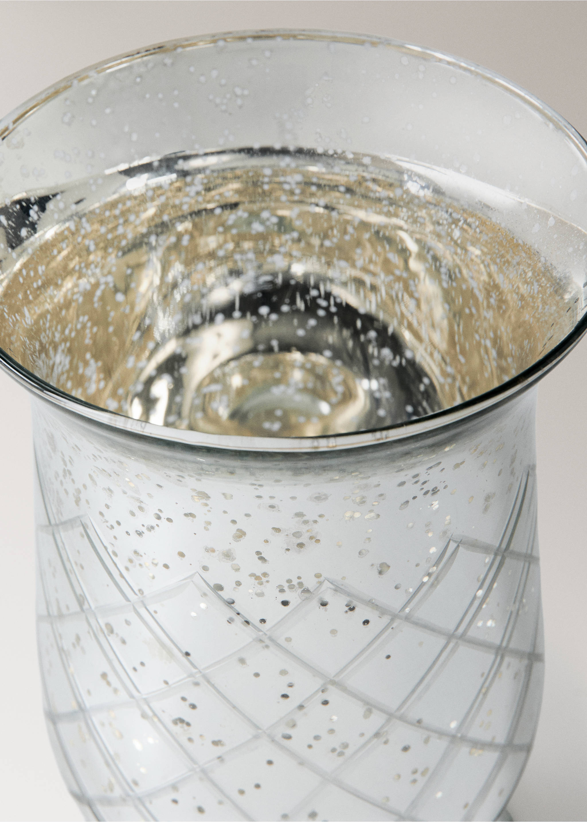 Close-up of a speckled silver glass candle holder with an etched lattice pattern., Silver. Ref: 37007900-00.