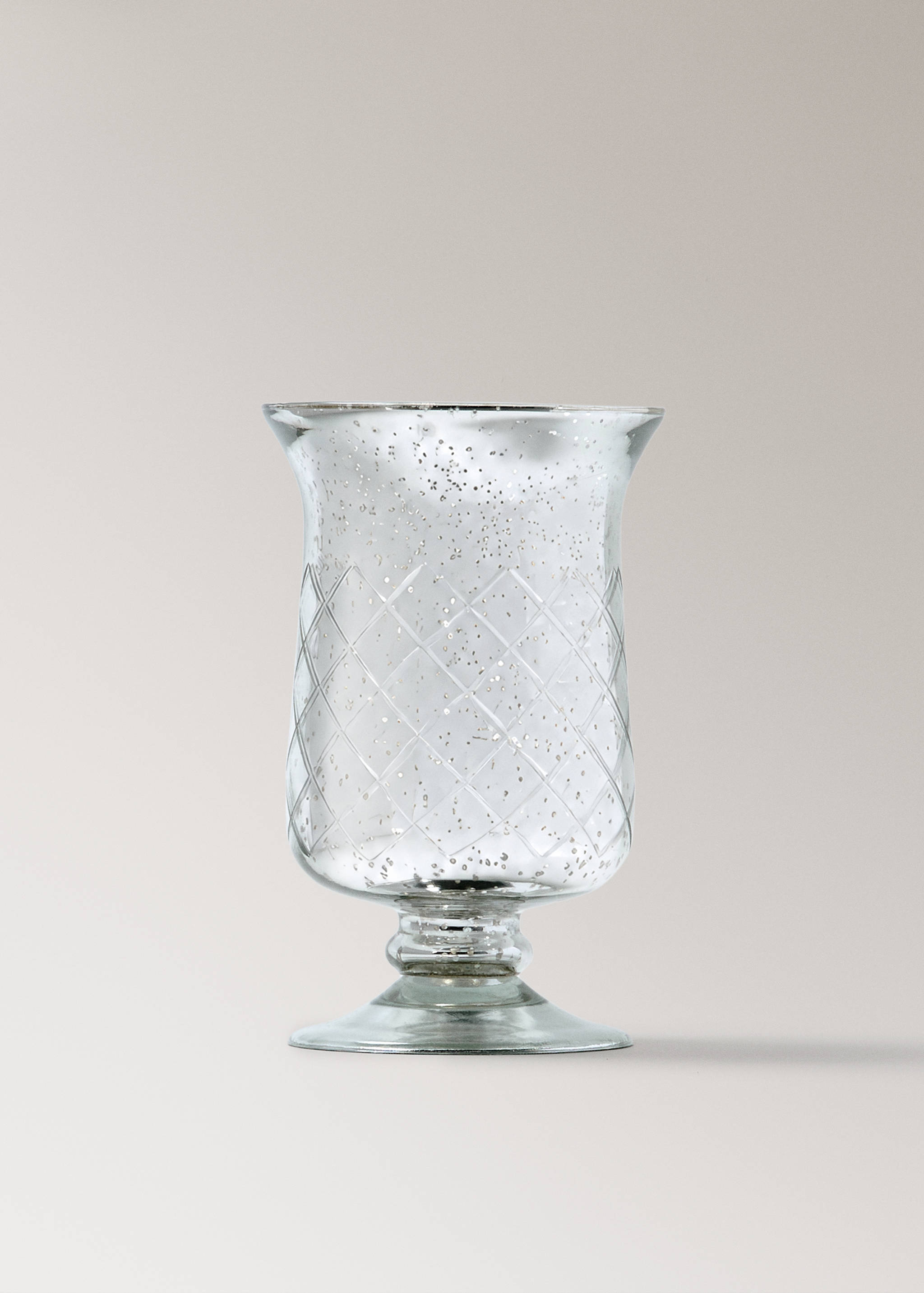Glass candle holder with a speckled silver finish and embossed diamond pattern.