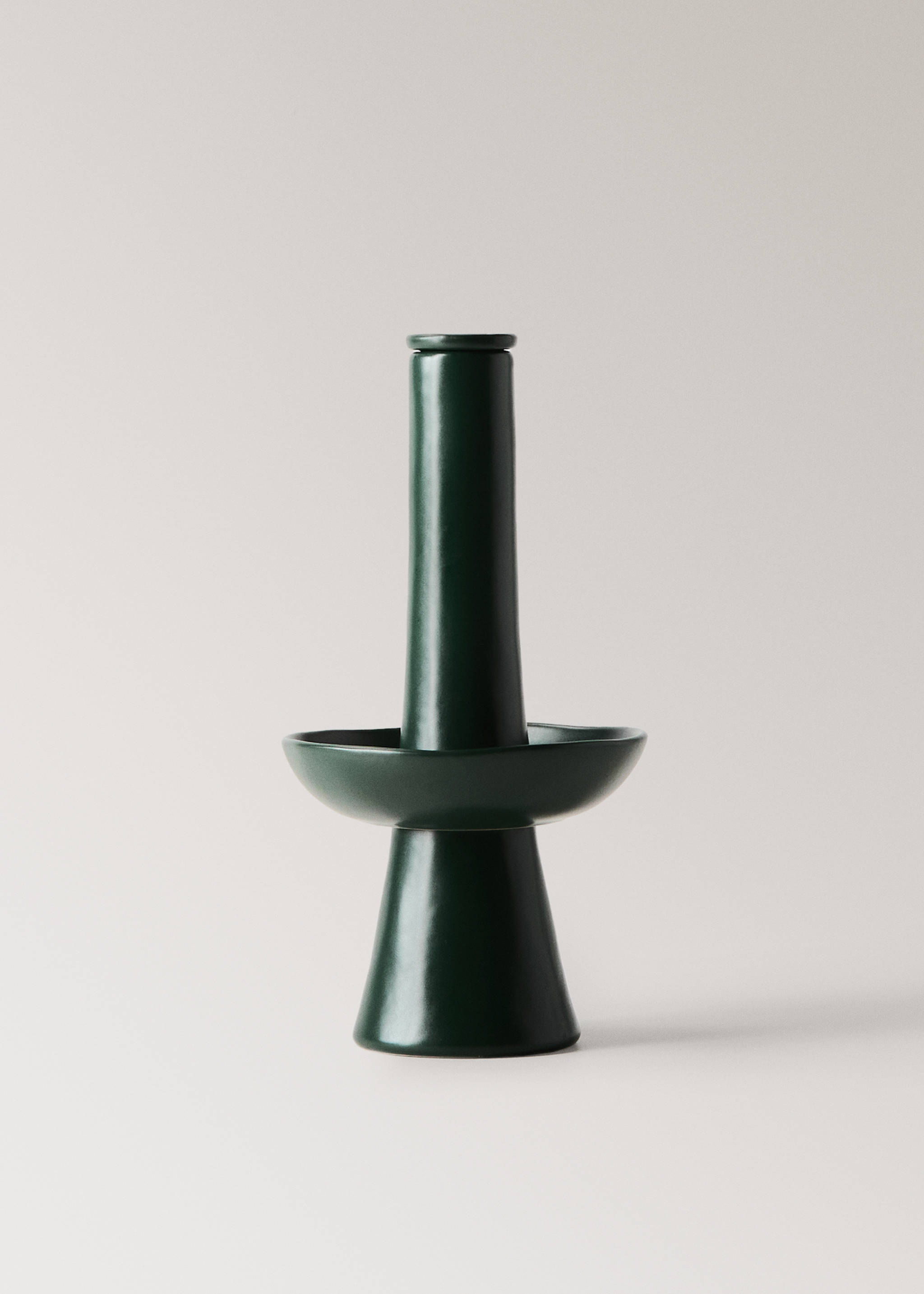 Dark green ceramic candle holder with a glossy finish and a flared base.