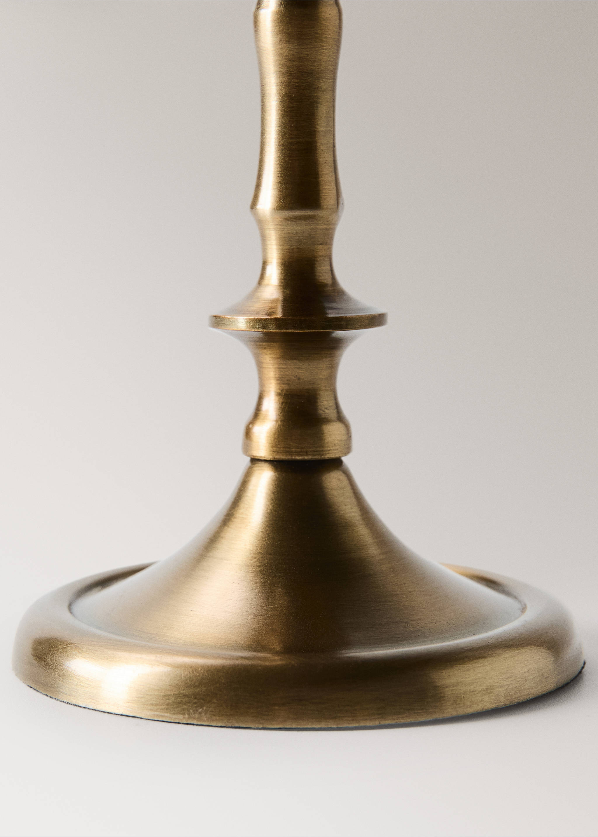 Close-up of a brushed antique brass candle holder base., Gold. Ref: 37007903-00.