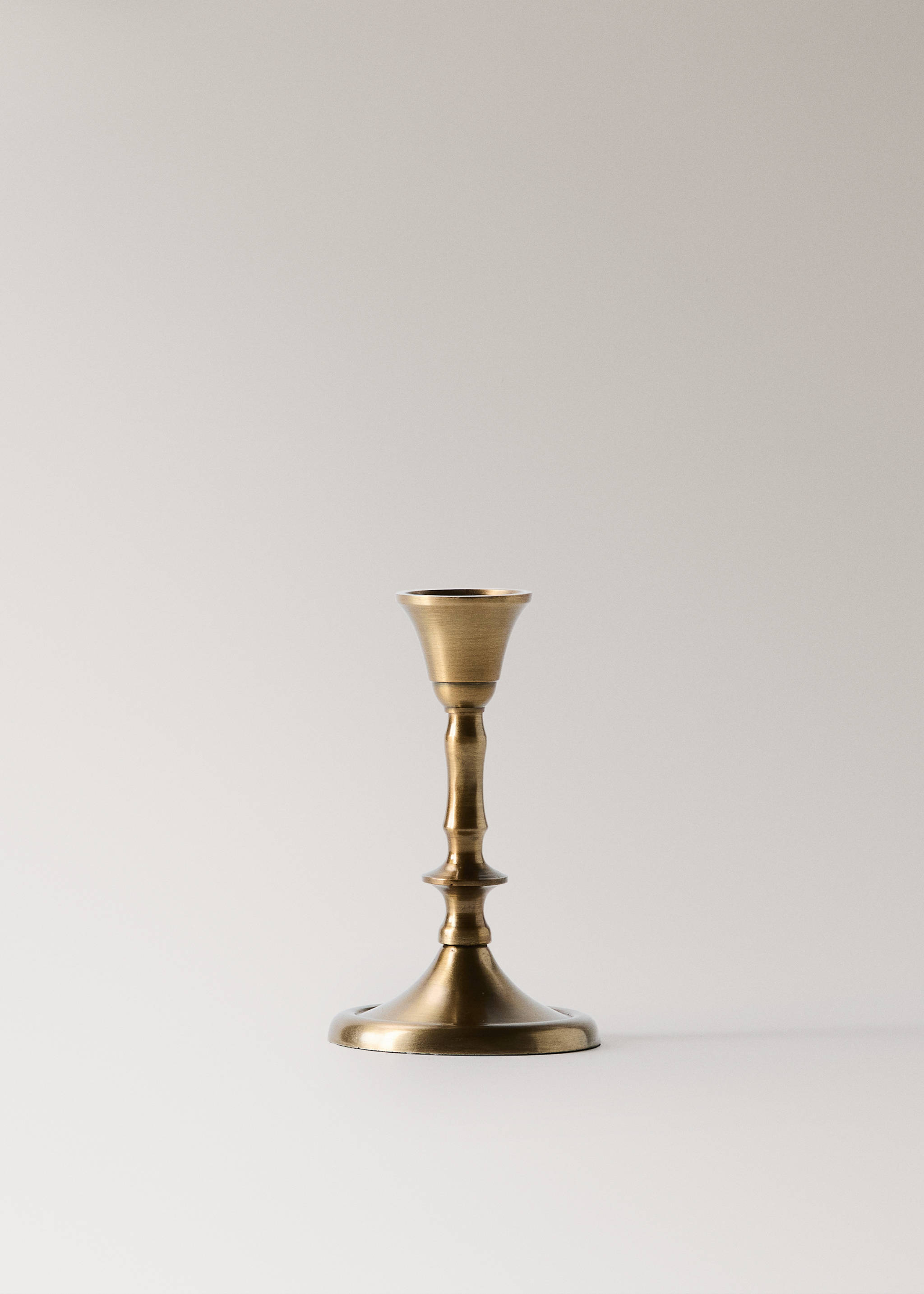 A brass candlestick holder with a classic turned stem and wide base.