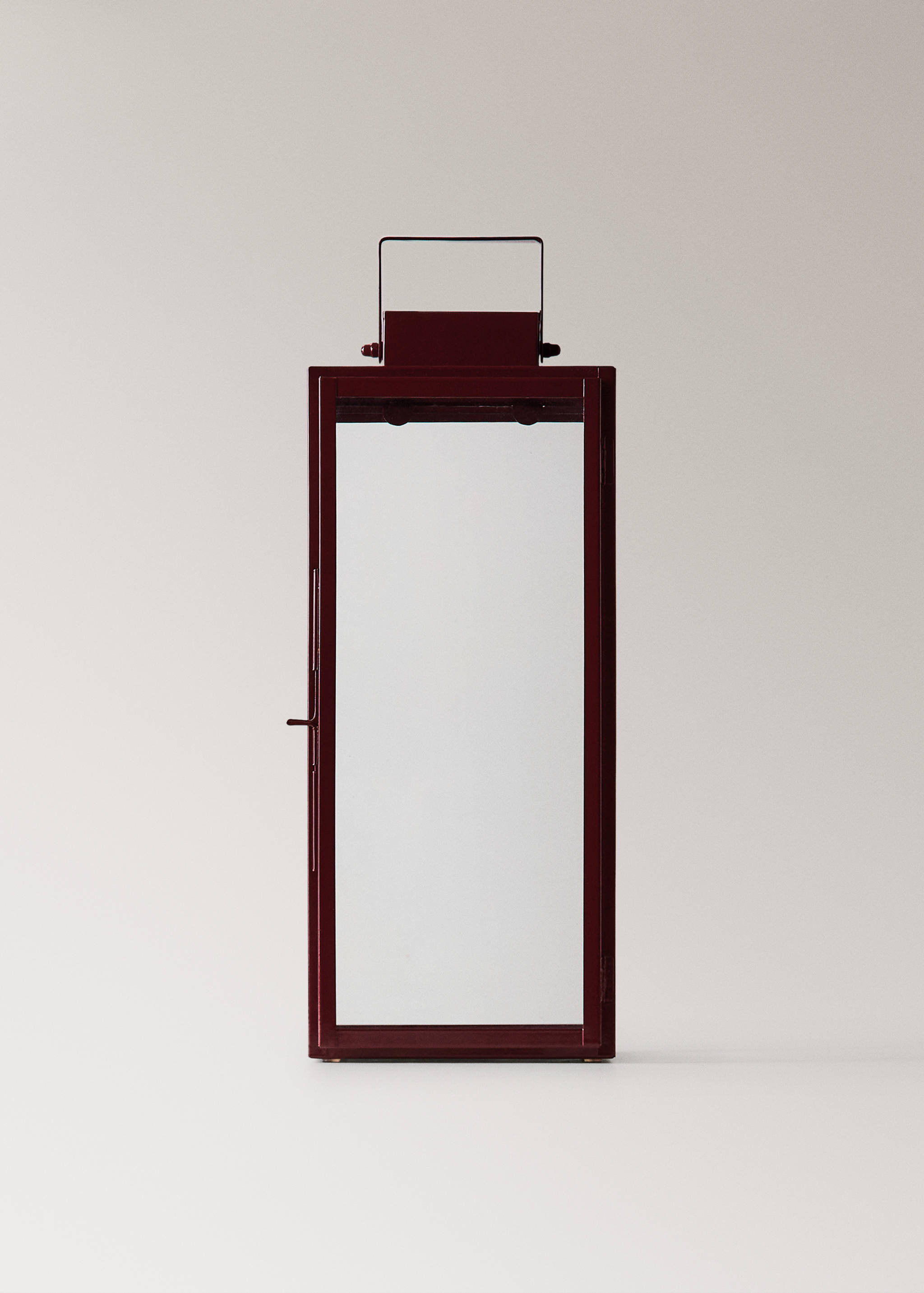 Burgundy metal candle holder with glass panels and a top handle.