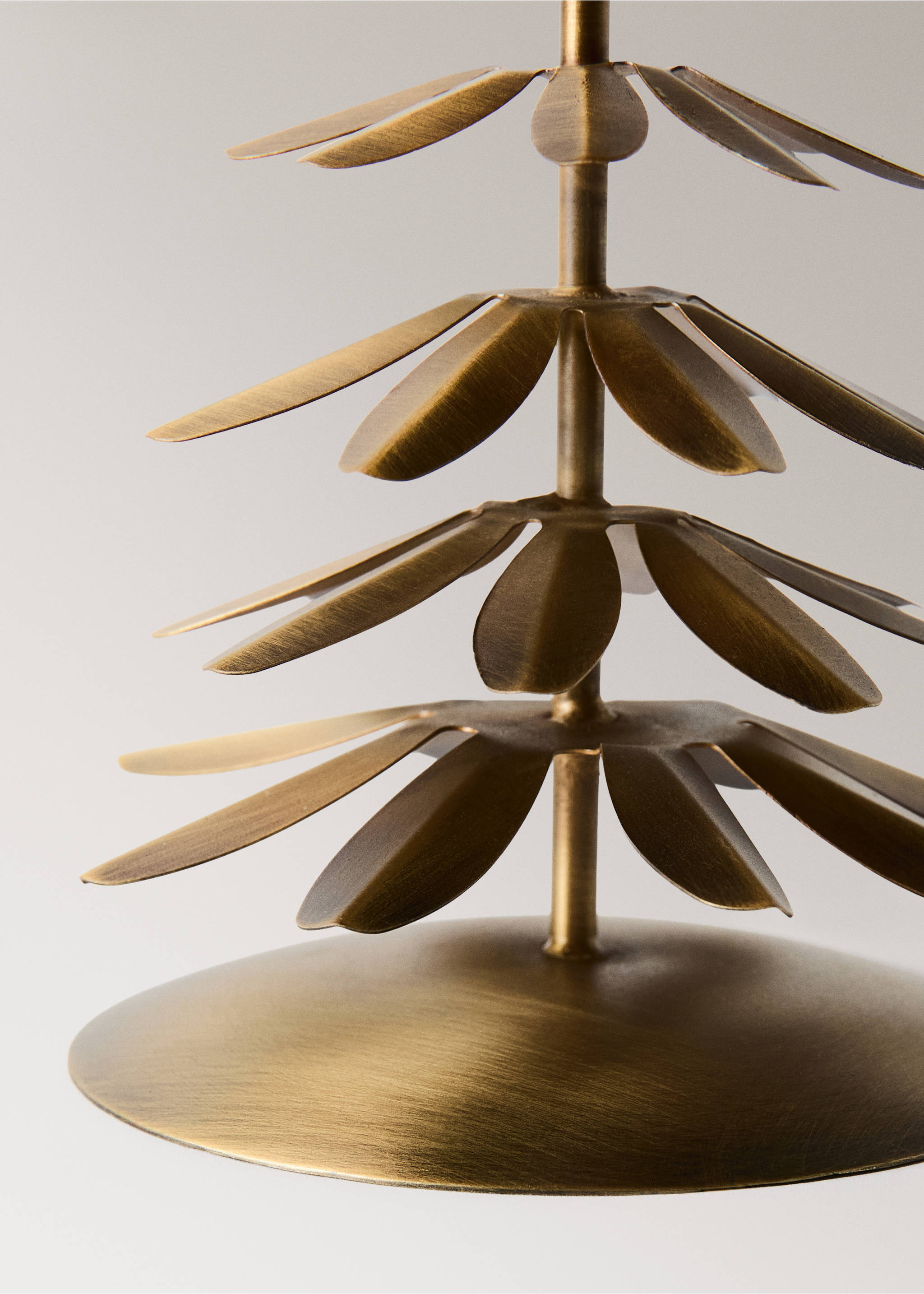 Close-up of a brushed golden metal candle holder with radiating petal tiers., Gold. Ref: 37007909-00.