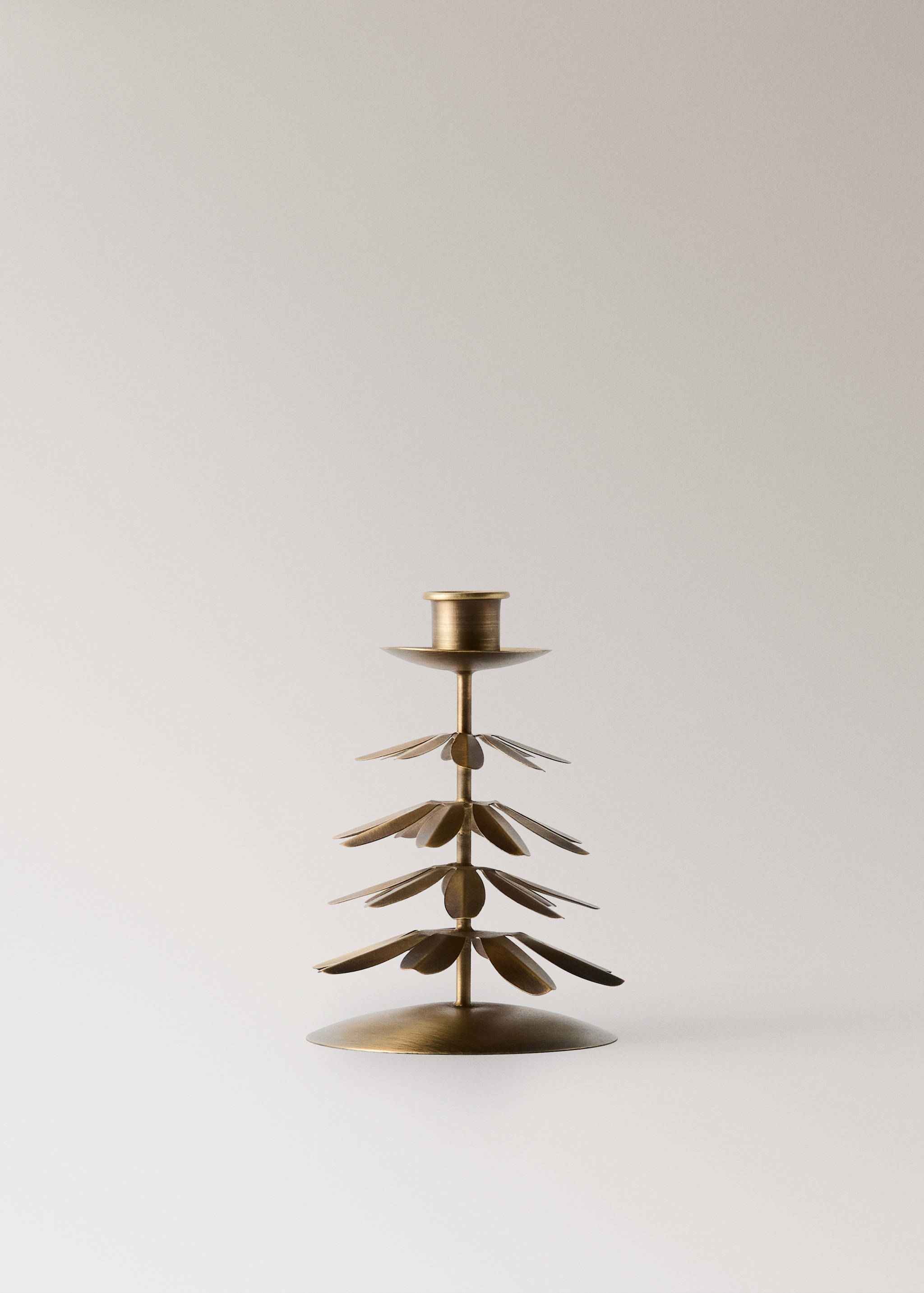 Brass-coloured metal candle holder with a tree-like tier of leaves.
