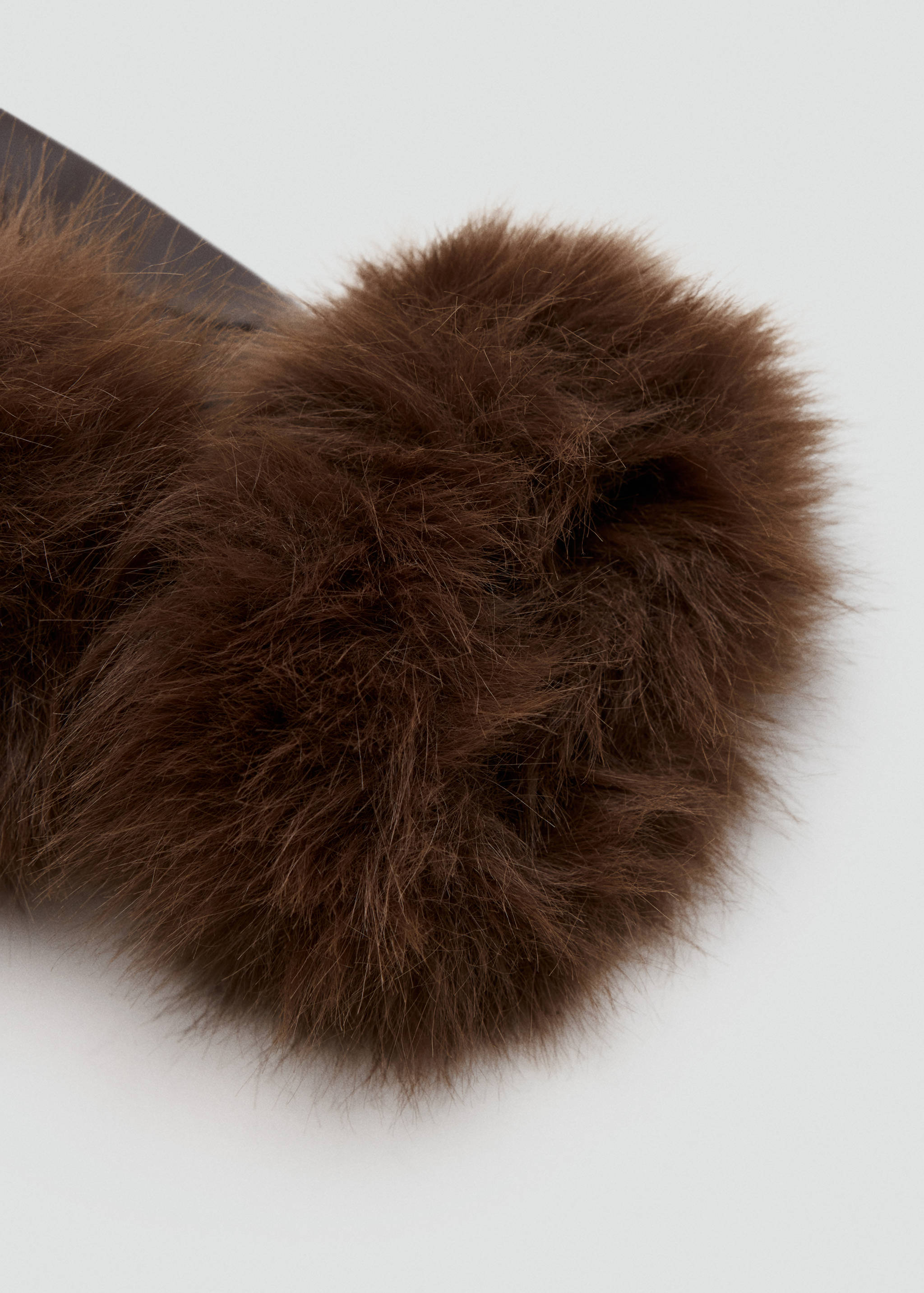 Brown gloves with voluminous faux-fur cuffs, close-up view.